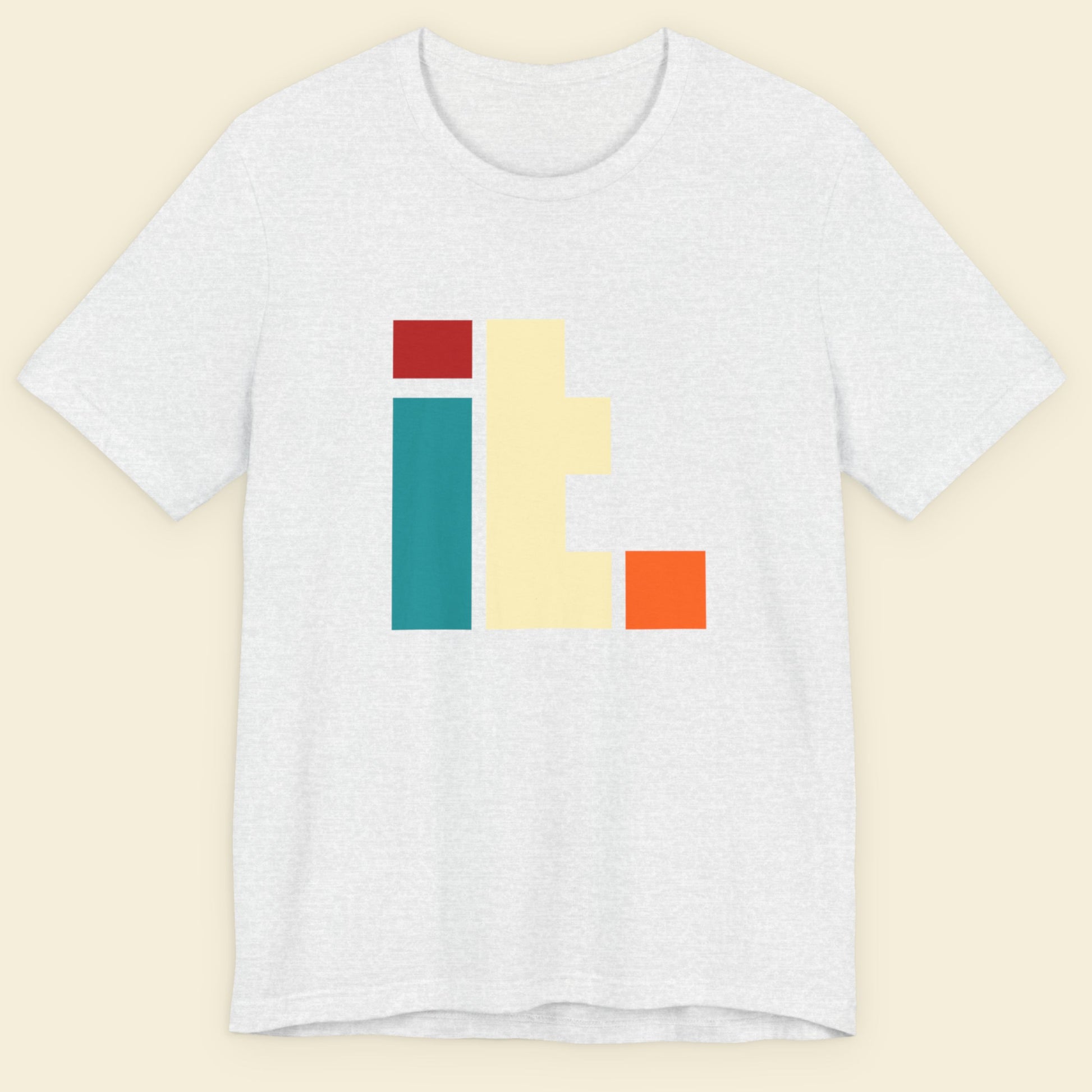 Ash grey t-shirt with colorful geometric design on a beige background.