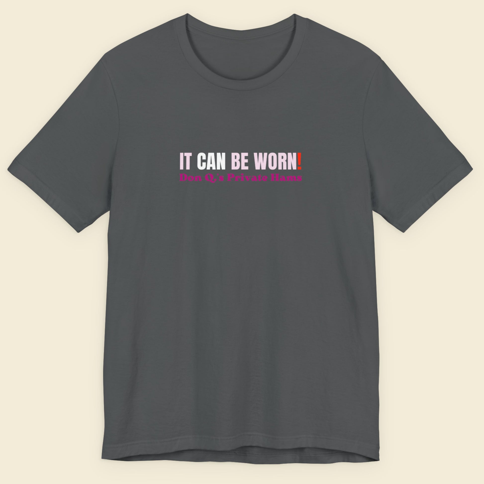 Gray t-shirt with text on a beige background.