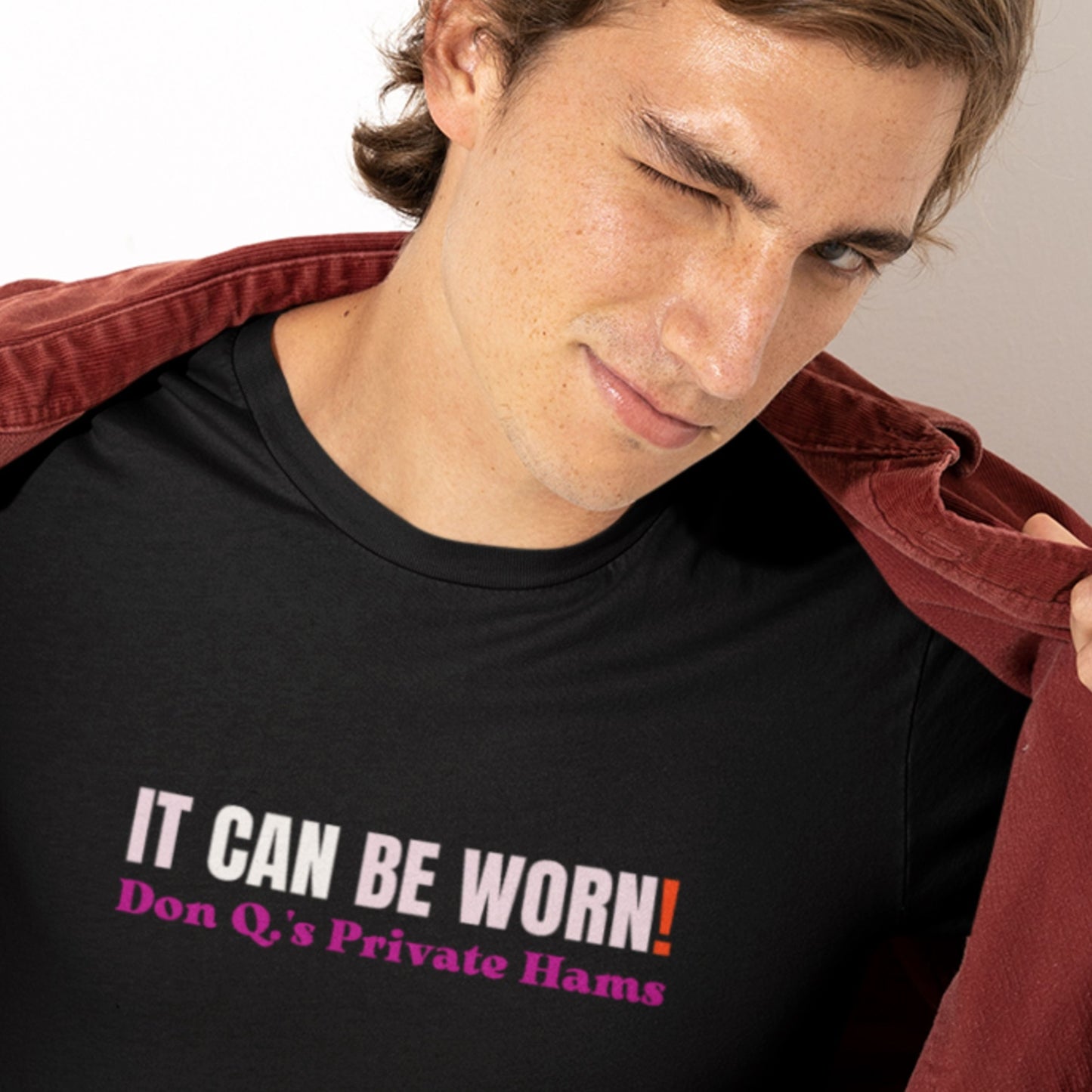 Person wearing a black t-shirt with humorous text design.