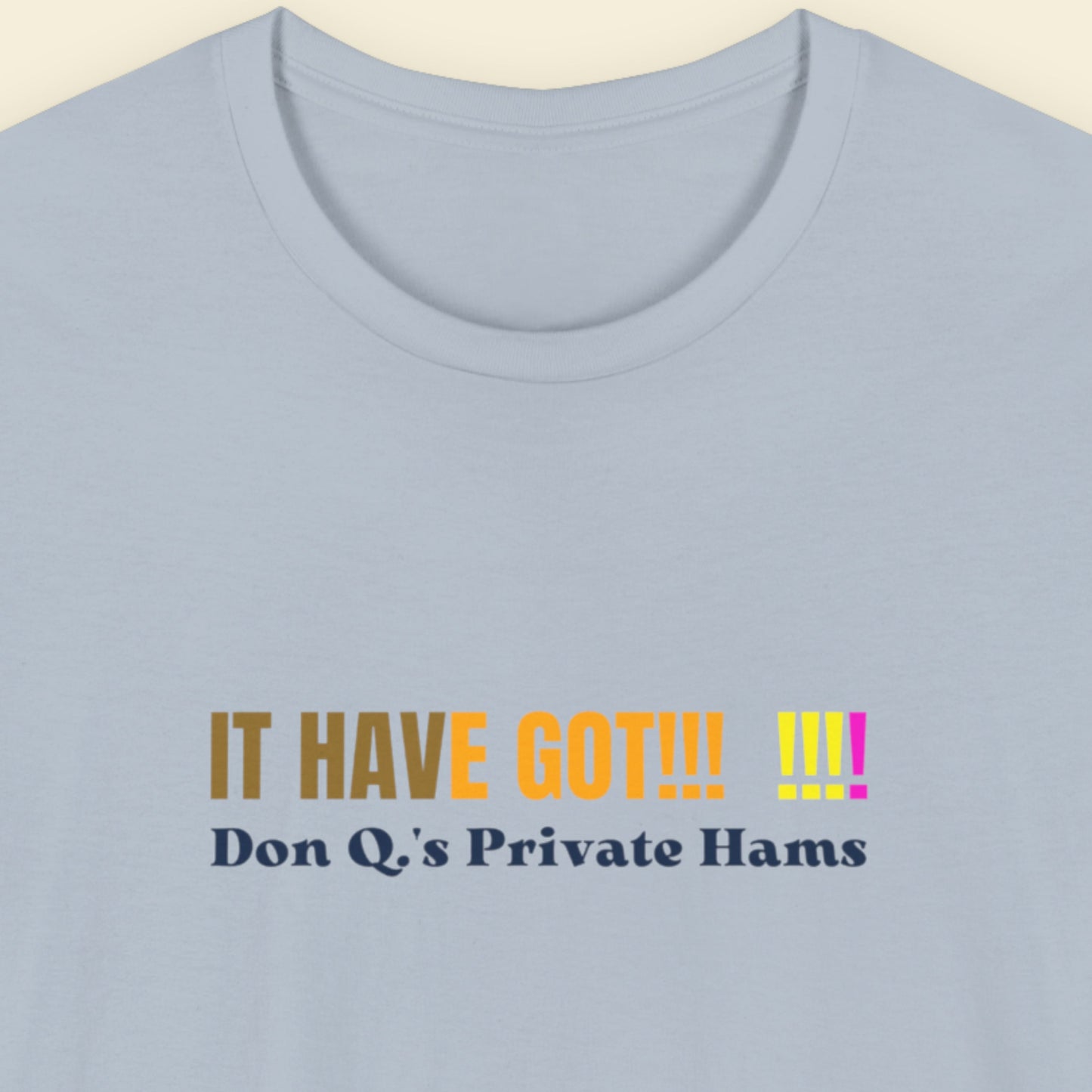 Light blue shirt with colorful nonsensical text on a beige background.