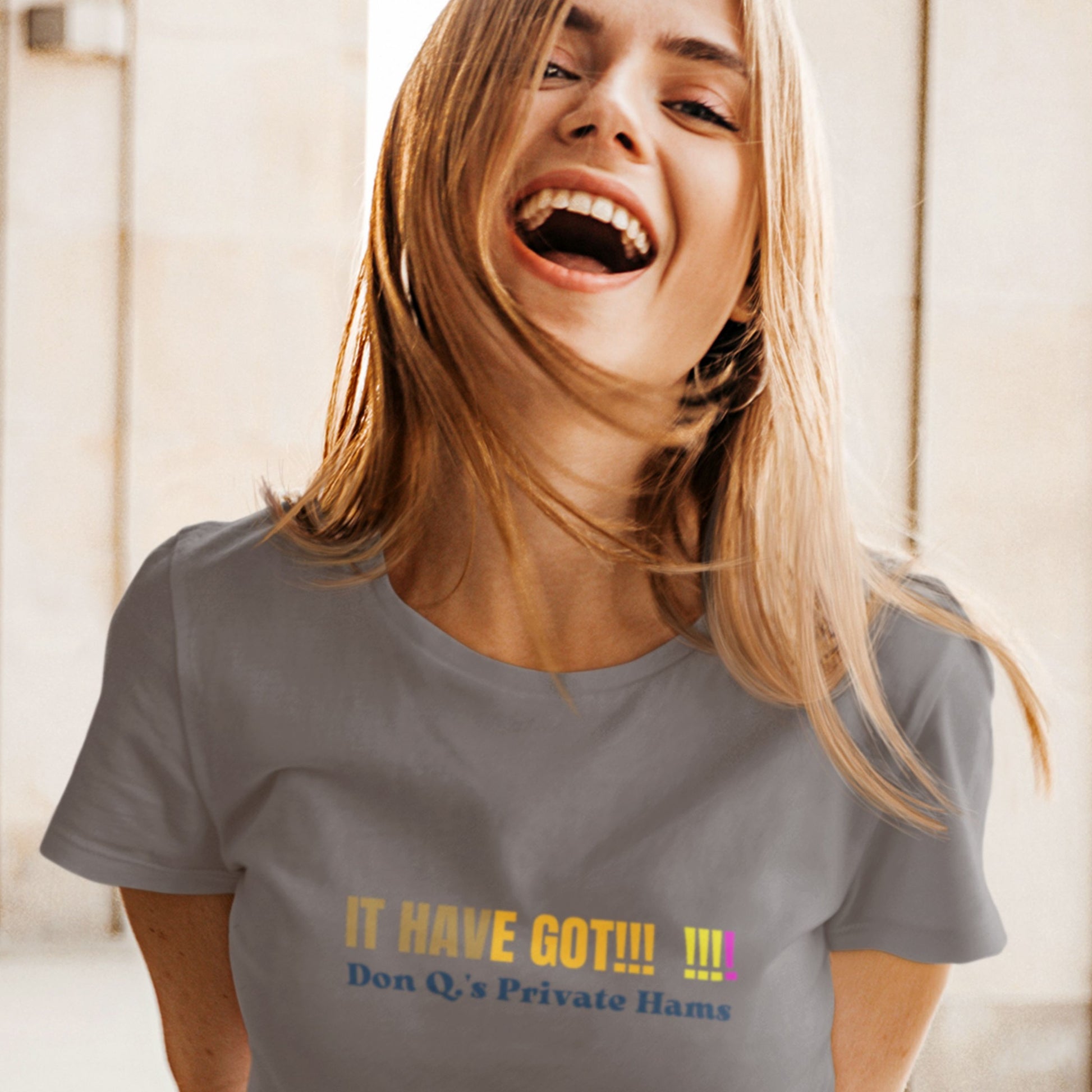 Woman wearing a dark grey shirt with colorful nonsensical text outside.