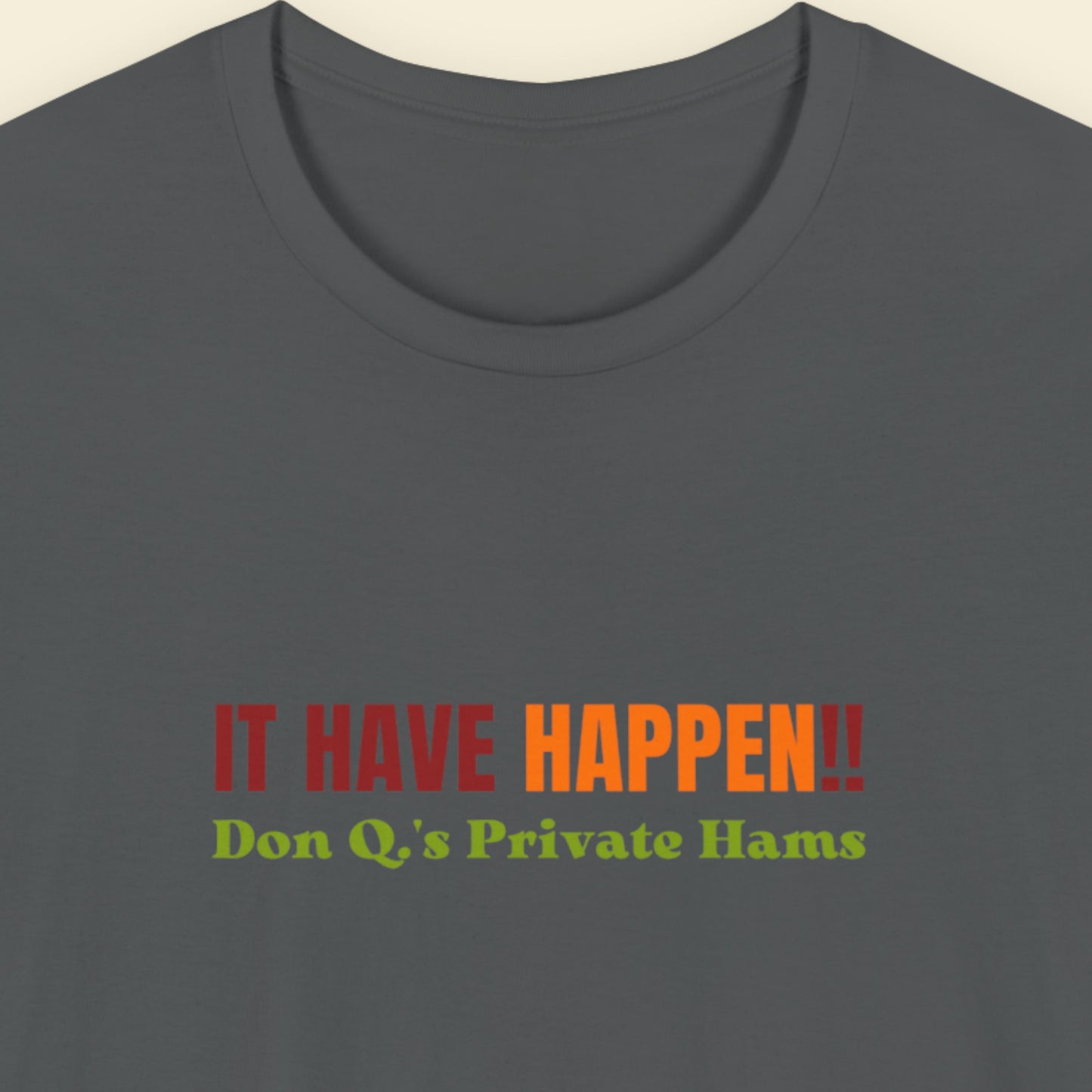 Gray t-shirt with colorful text on a beige background.