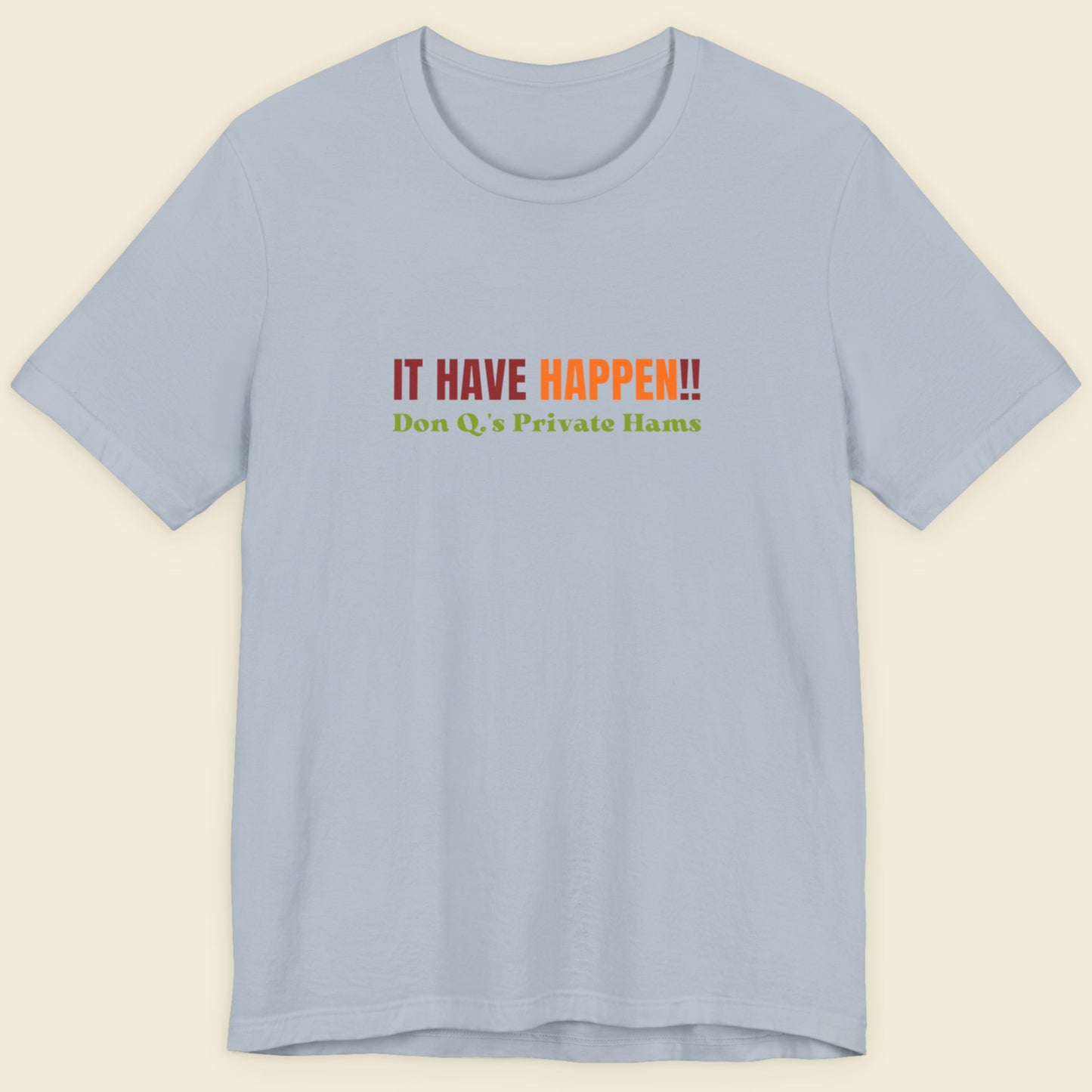 Light blue t-shirt with colorful text on a beige background.