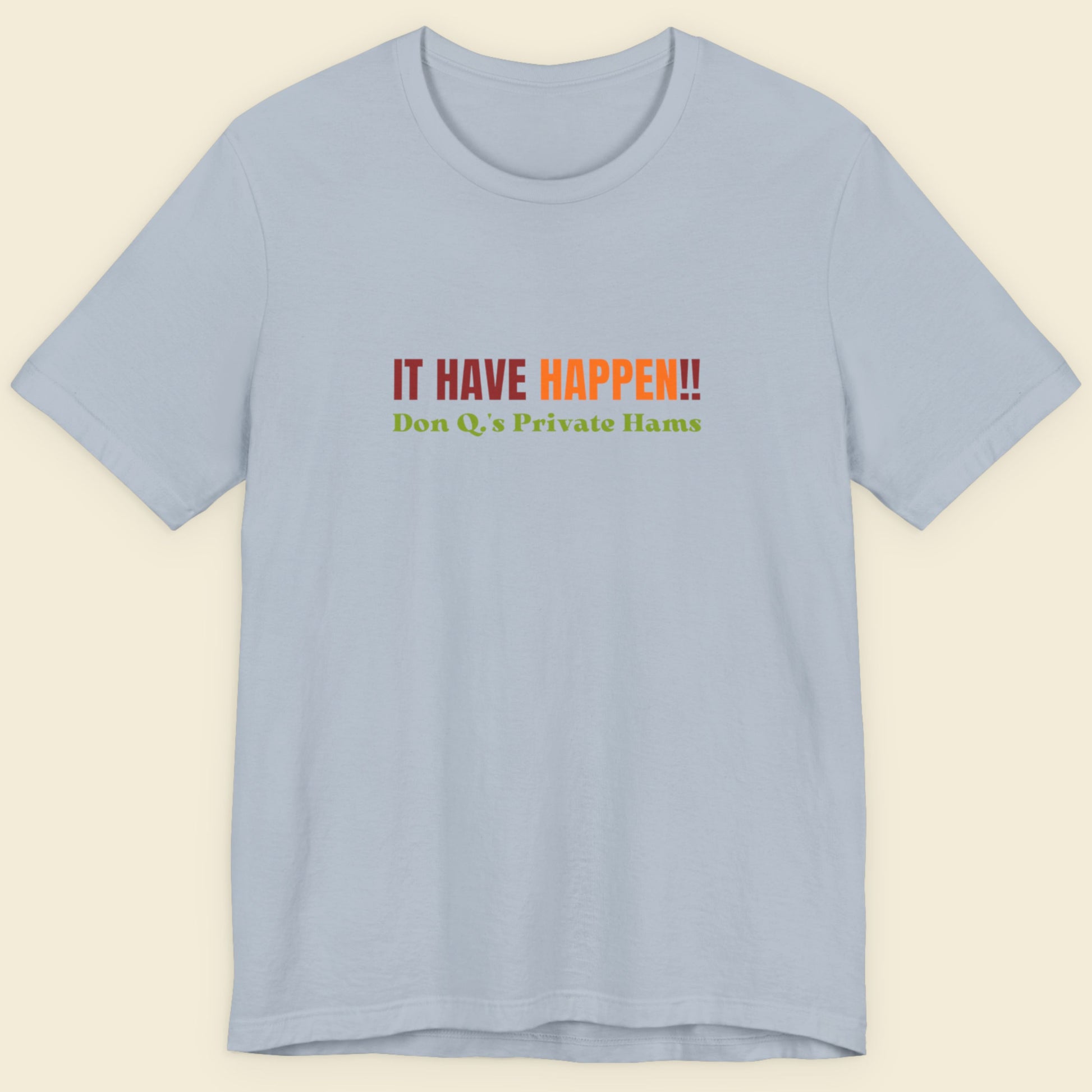 Light blue t-shirt with colorful text on a beige background.