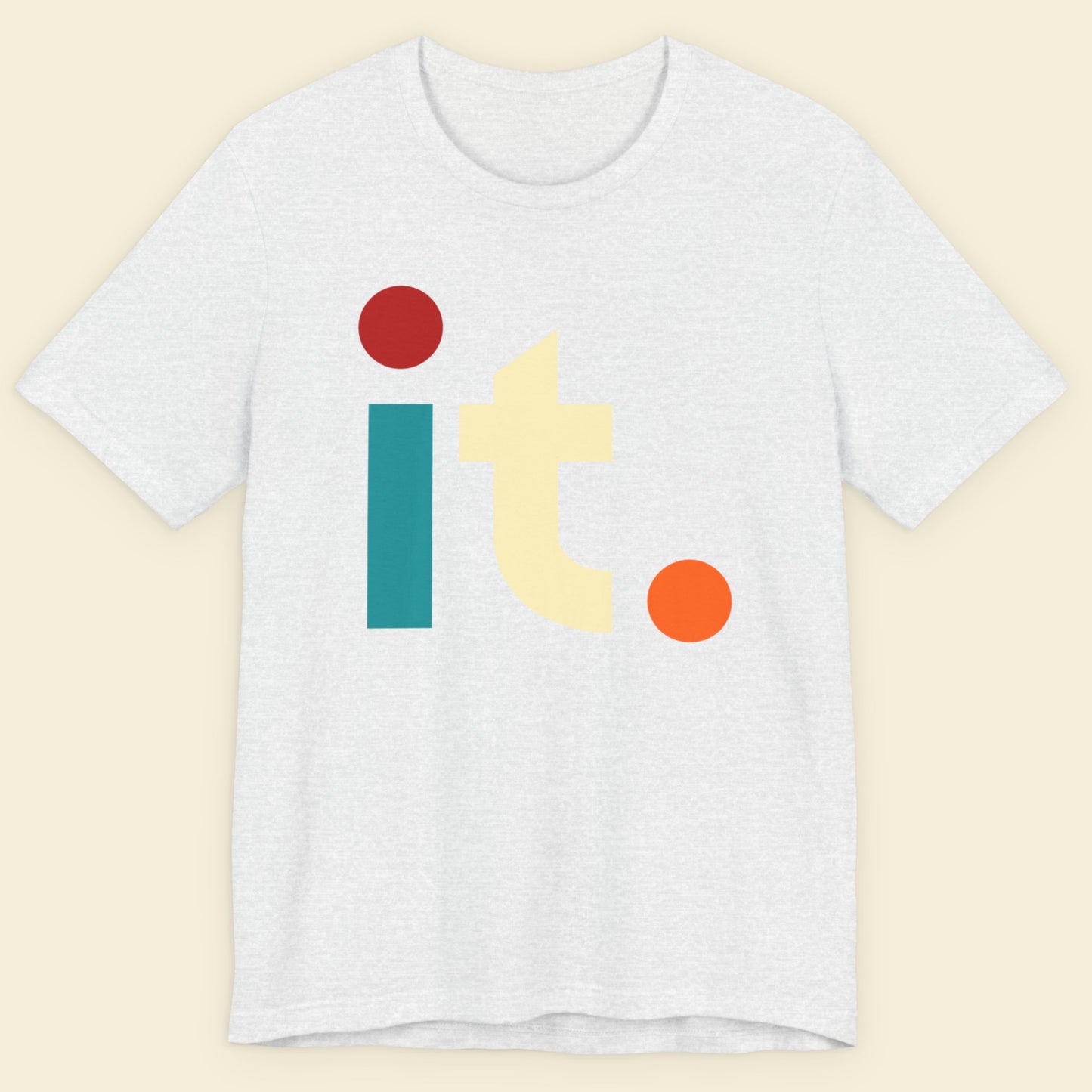 White t-shirt with colorful 'it.' graphic on a beige background.