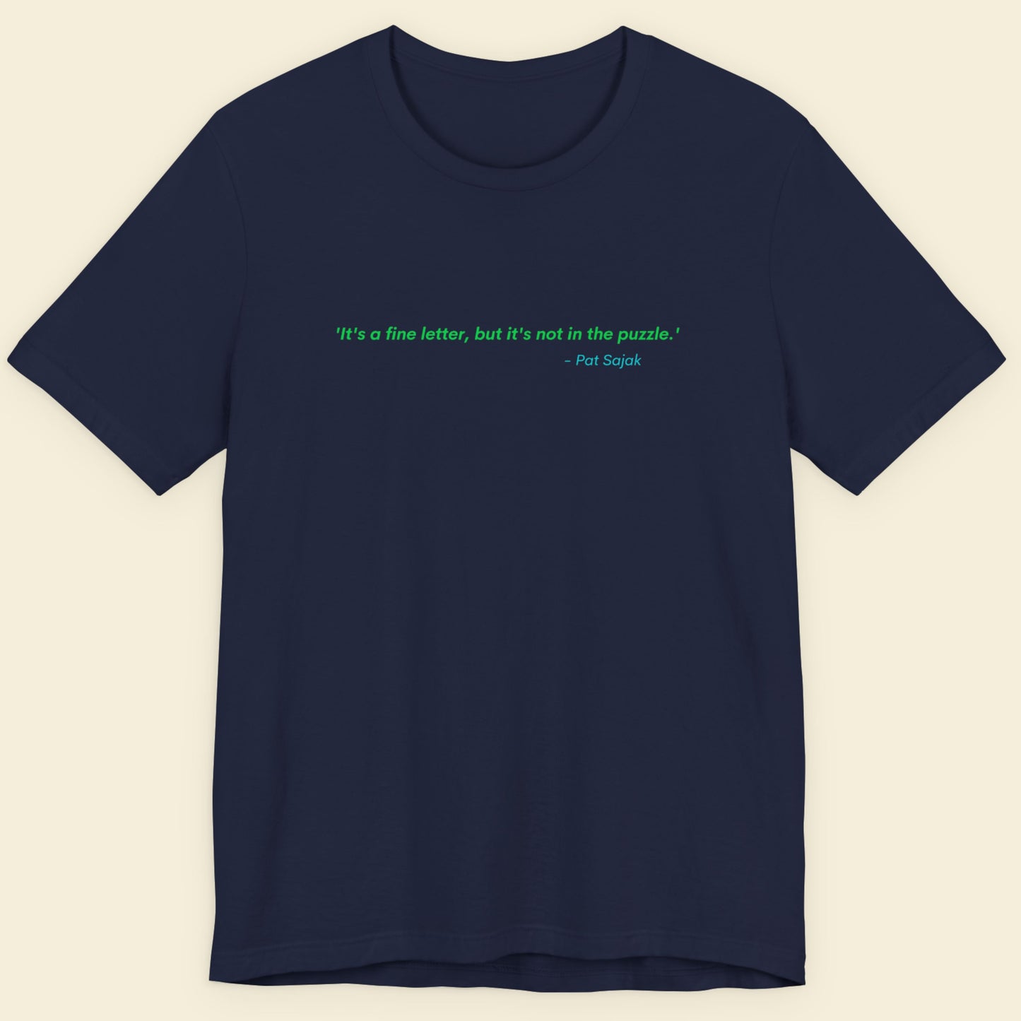 Navy blue t-shirt with a green quote on a beige background.