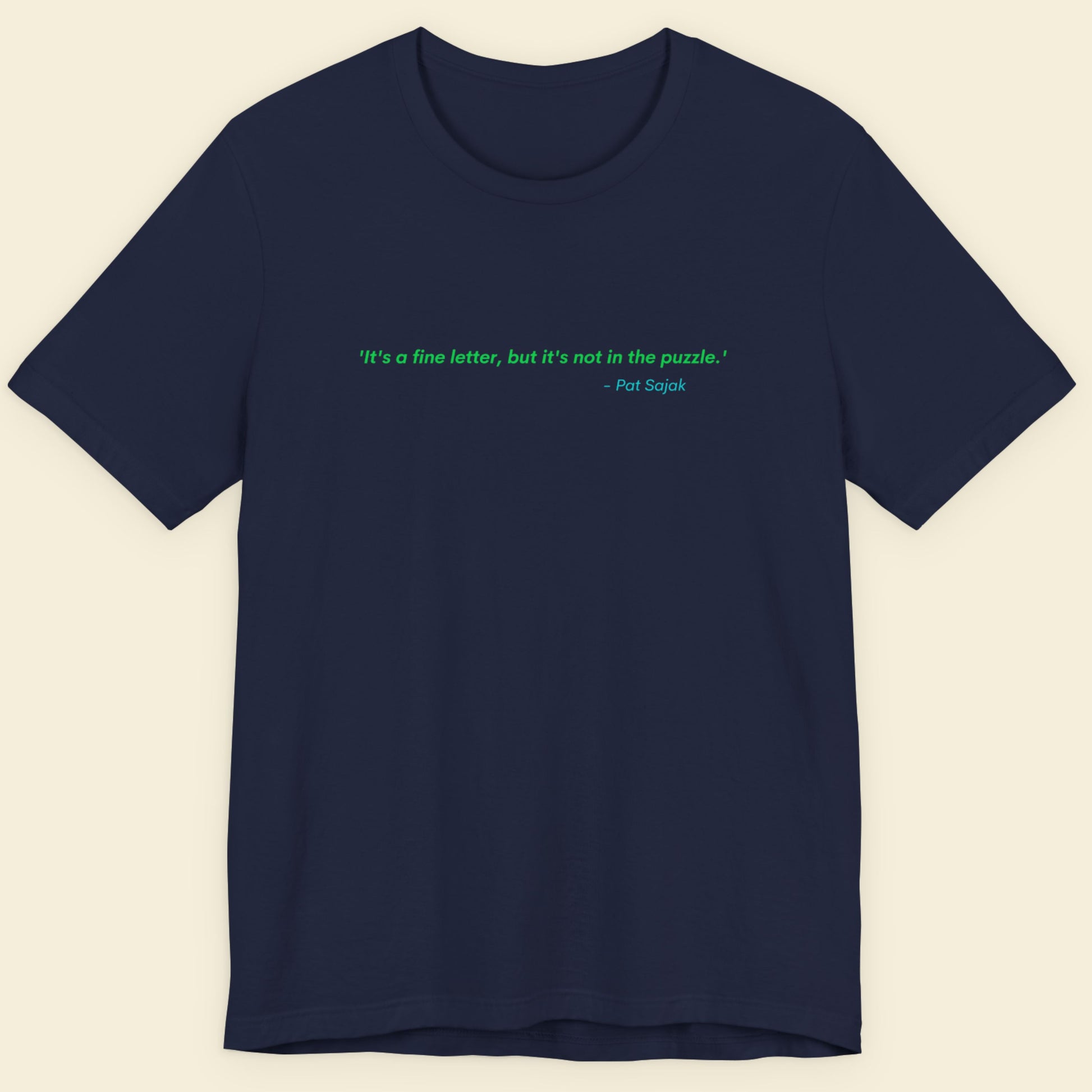 Navy blue t-shirt with a green quote on a beige background.