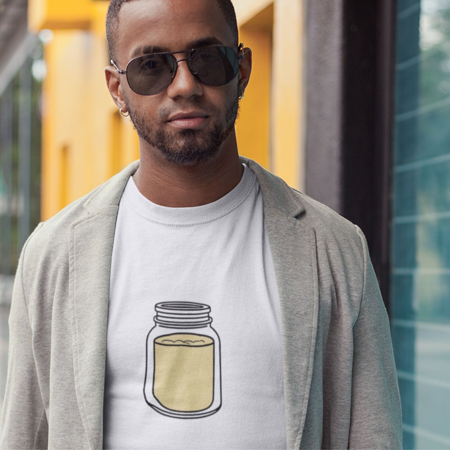 Man wearing a t-shirt with a jar design outdoors.