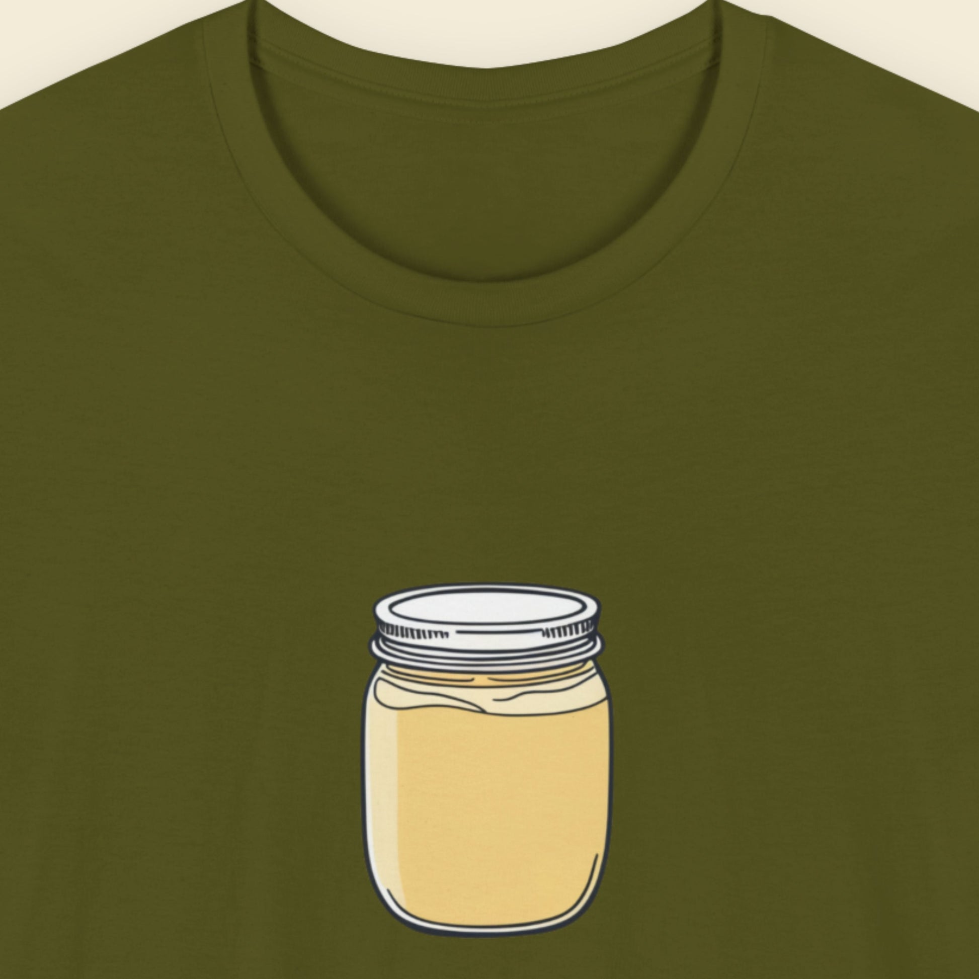 Olive green shirt with a drawing of a jar of yellow cream.