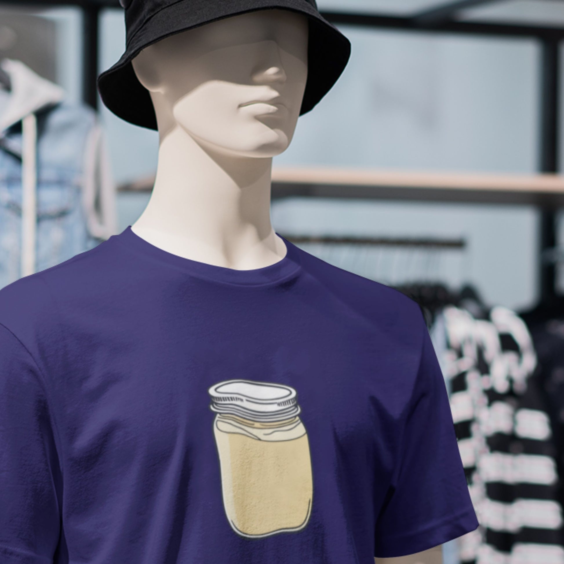 Mannequin wearing a navy blue t-shirt with a jar design outdoors.