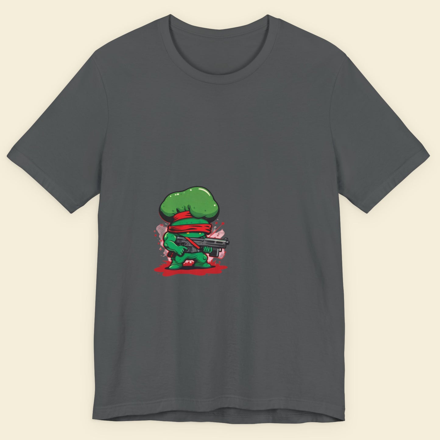 Gray t-shirt with a green character holding a gun on a beige background