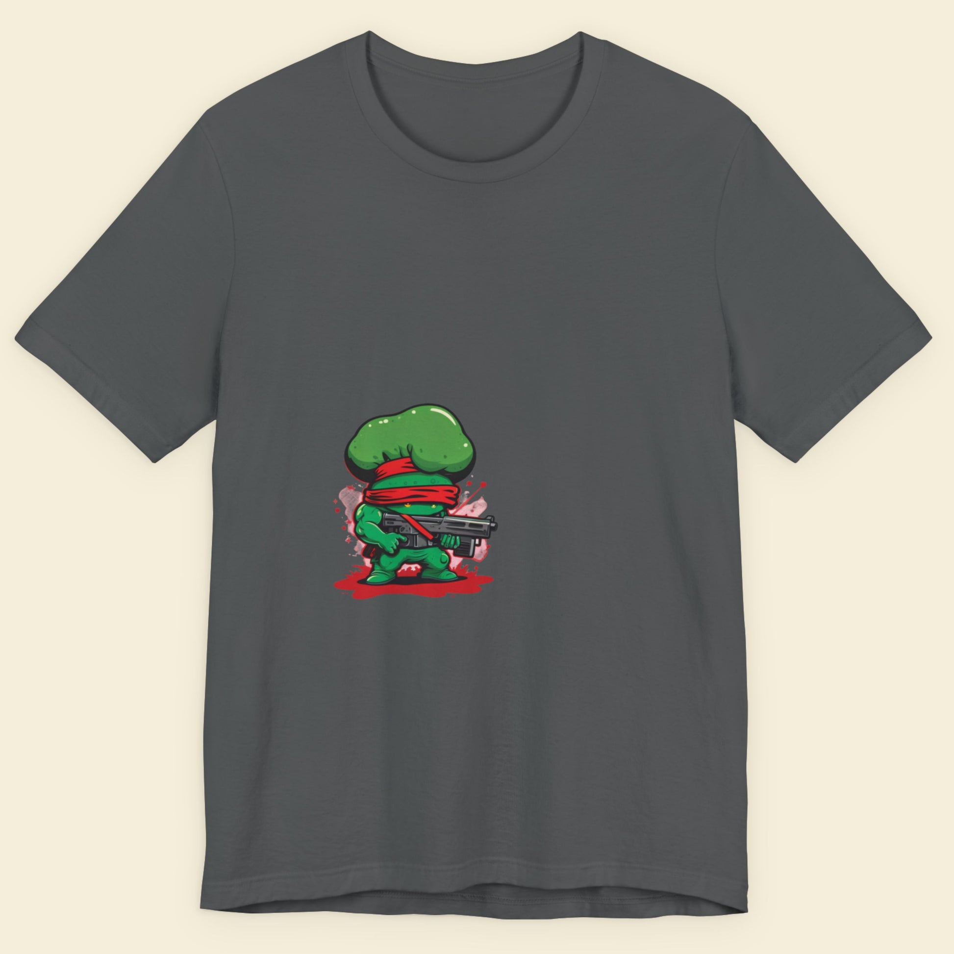 Gray t-shirt with a green character holding a gun on a beige background