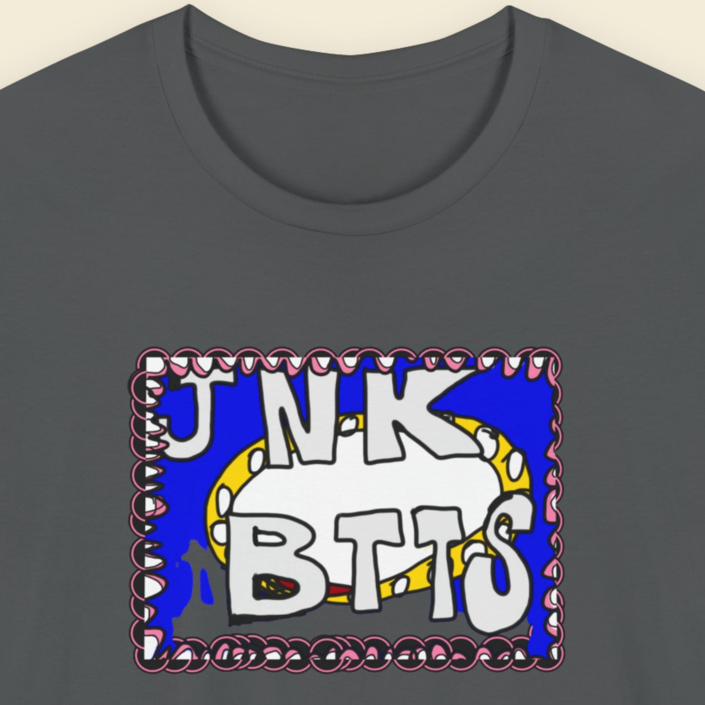 Gray t-shirt with colorful graphic design on a beige background.