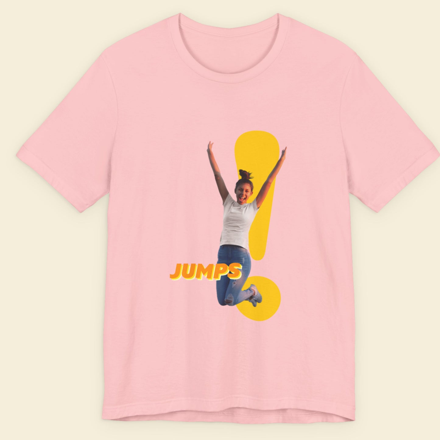Pink t-shirt with a graphic of a person jumping and the word 'JUMPS' on a beige background.