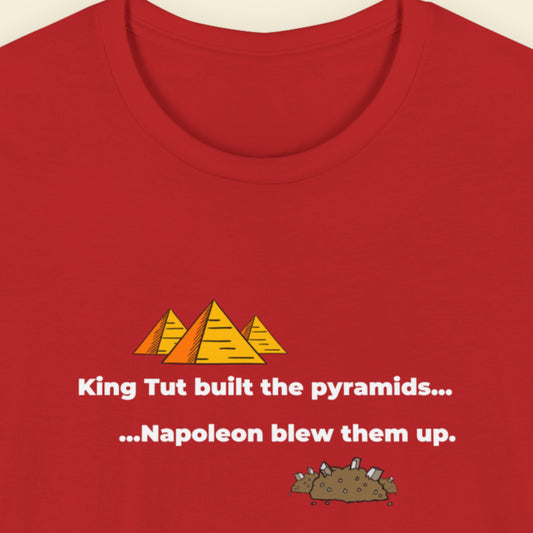 Red t-shirt with humorous colorful text on a beige background.