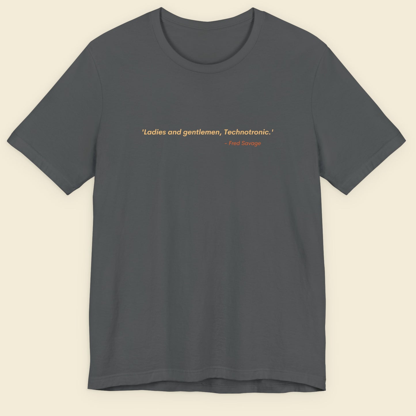 Gray t-shirt with text on a beige background.
