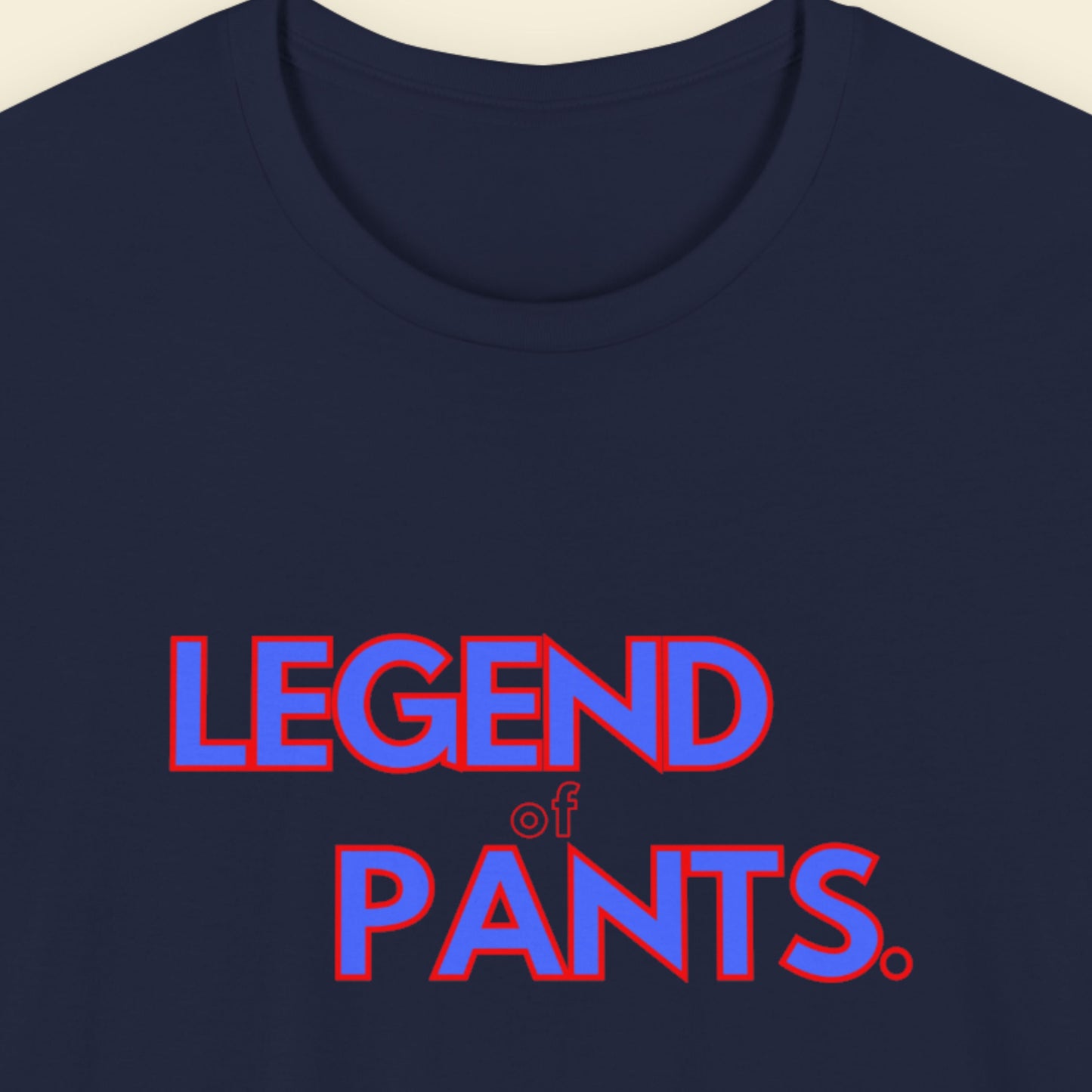 Navy blue t-shirt with 'LEGEND of Pants.' text in red and blue on a beige background.