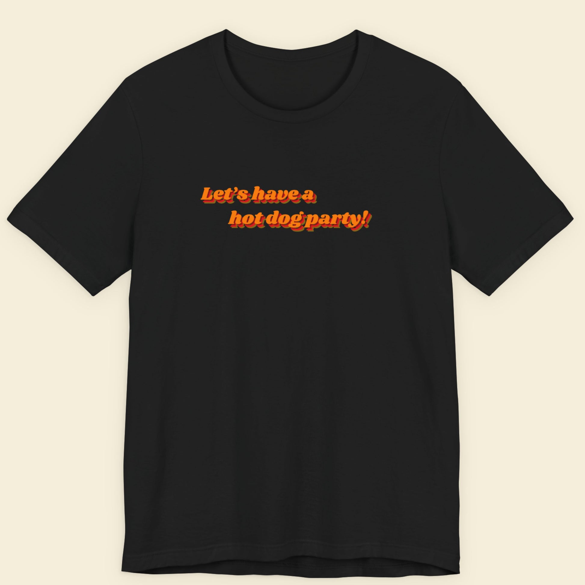 Black t-shirt with orange text 'Let's have a hot dog party!' on a beige background