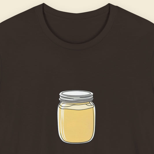 Brown t-shirt with a fun, colorful cartoon illustration on a beige background.