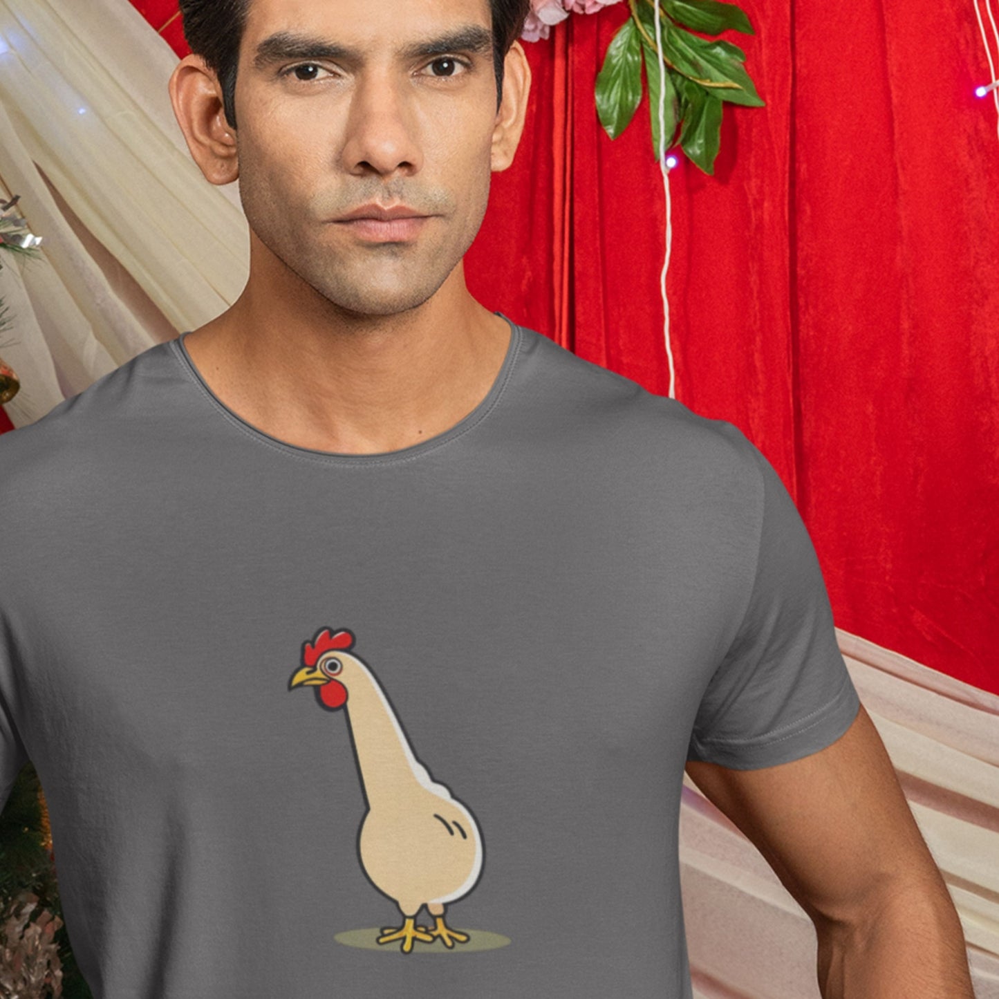Man wearing a dark grey shirt with an illustration of a long neck chicken.