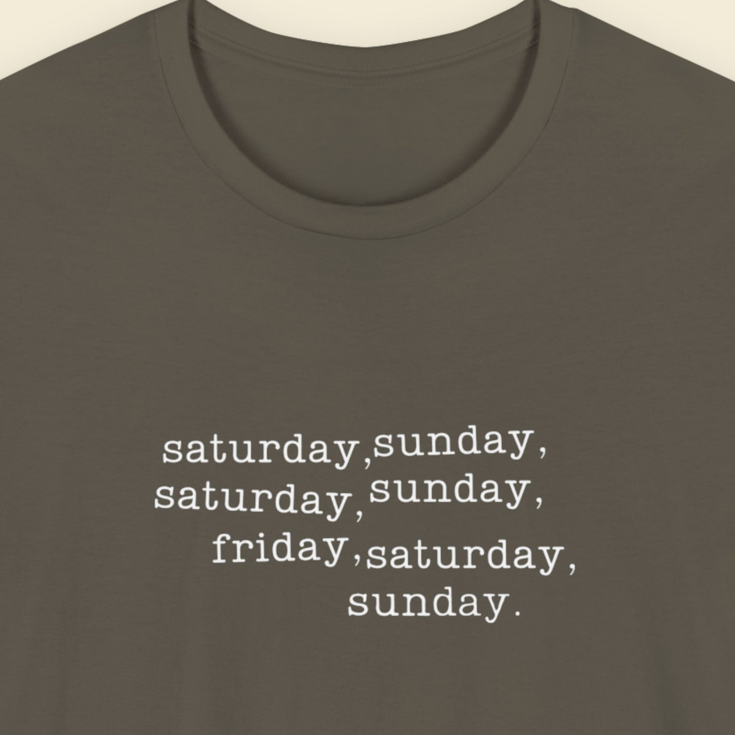 Army green shirt with humorous off-center text on a beige background.