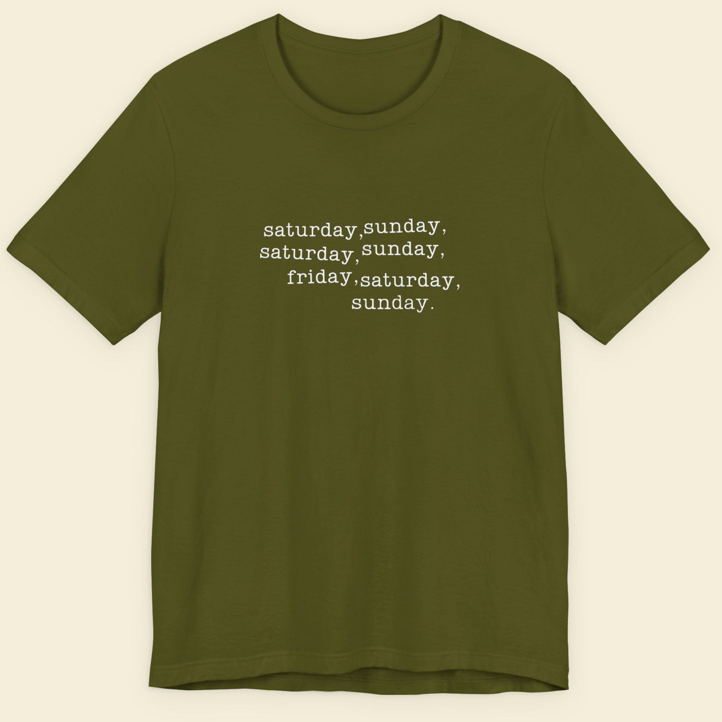 Olive green shirt with humorous off-center text on a beige background.