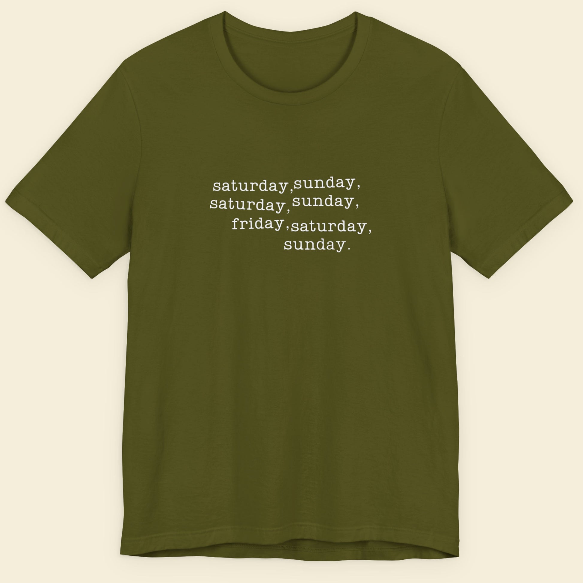 Olive green shirt with humorous off-center text on a beige background.