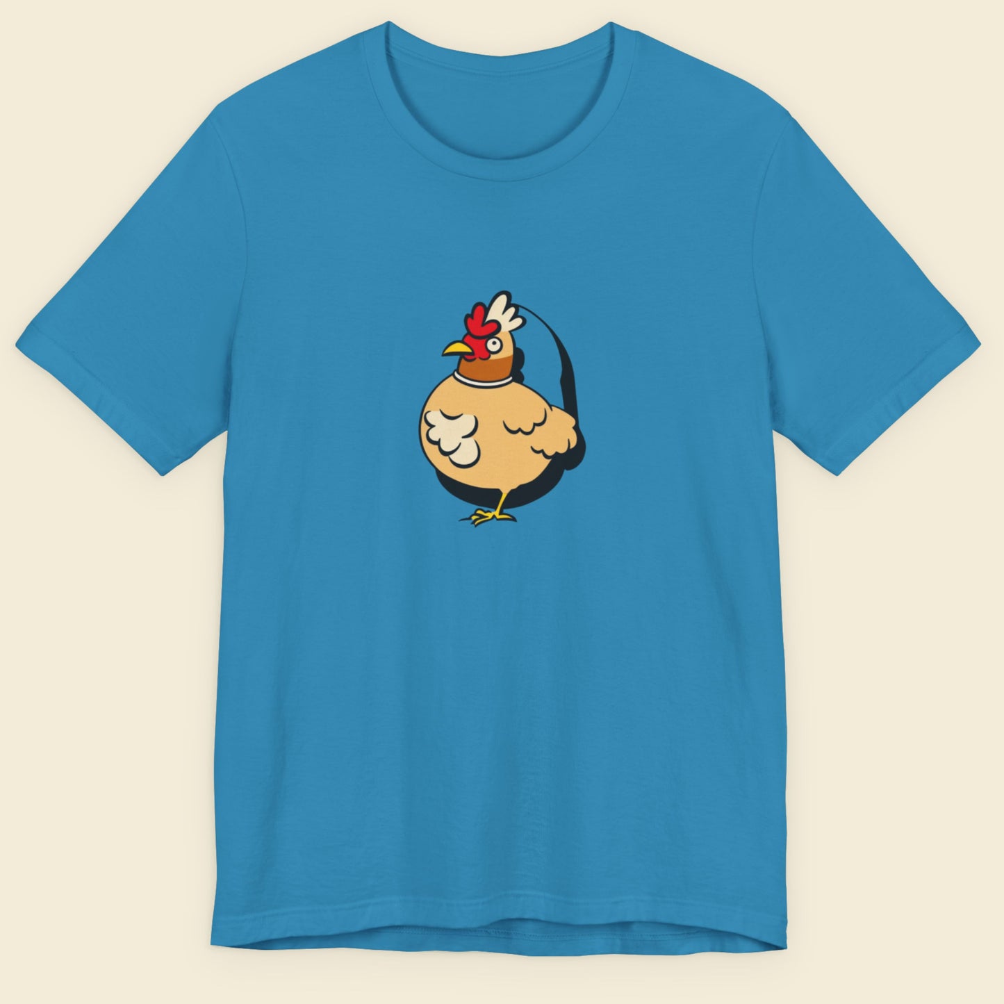 Blue t-shirt with a cartoon chicken design on a beige background