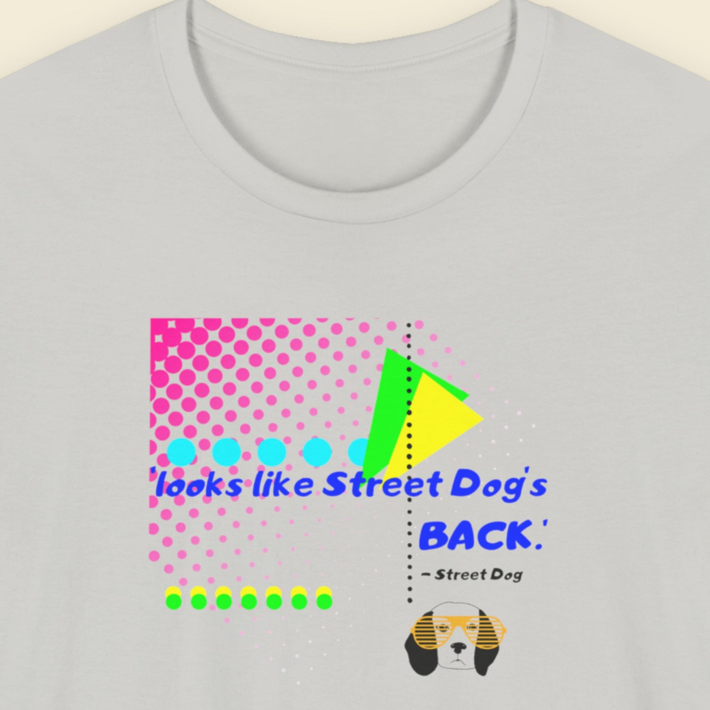 Gray t-shirt with colorful graphic design and text on a beige background.