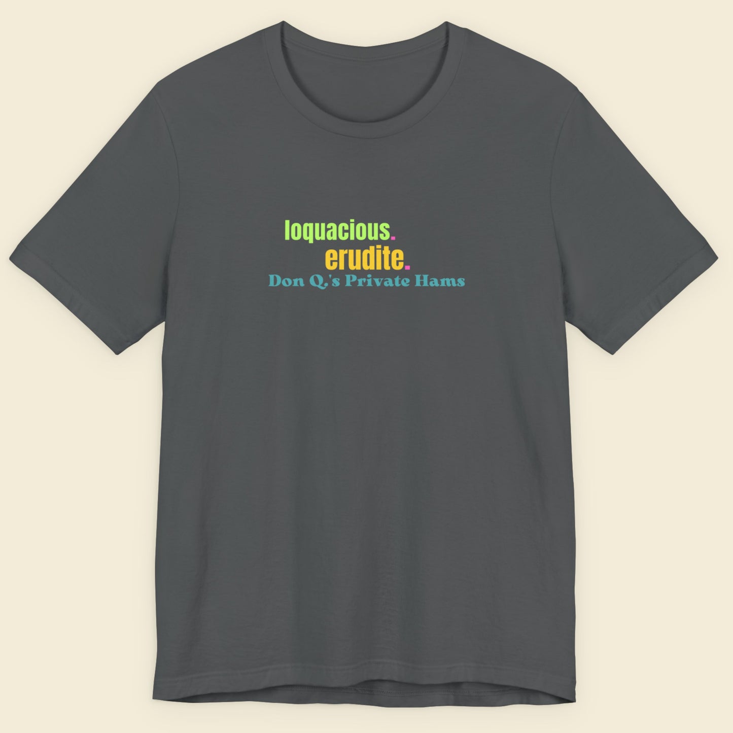 Gray t-shirt with colorful text on a beige background.