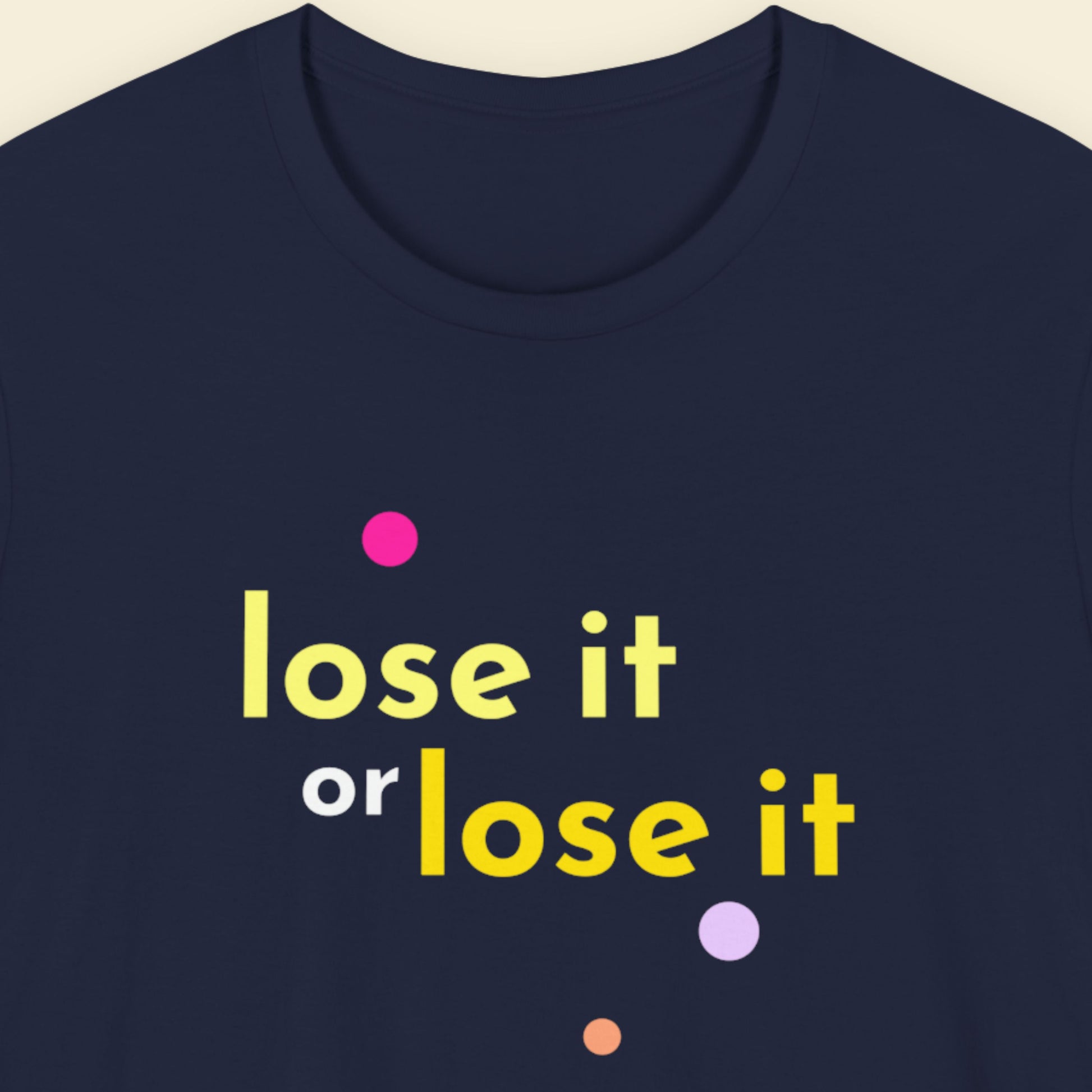 Navy blue t-shirt with 'lose it or lose it' text in yellow and pink dots on a beige background.