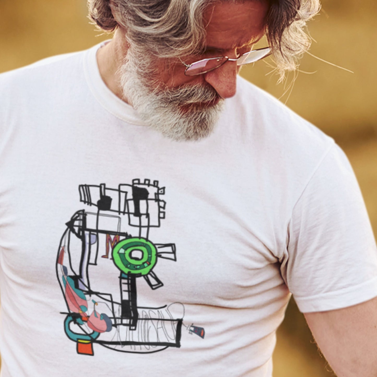 Man wearing a white t-shirt with a colorful abstract design.
