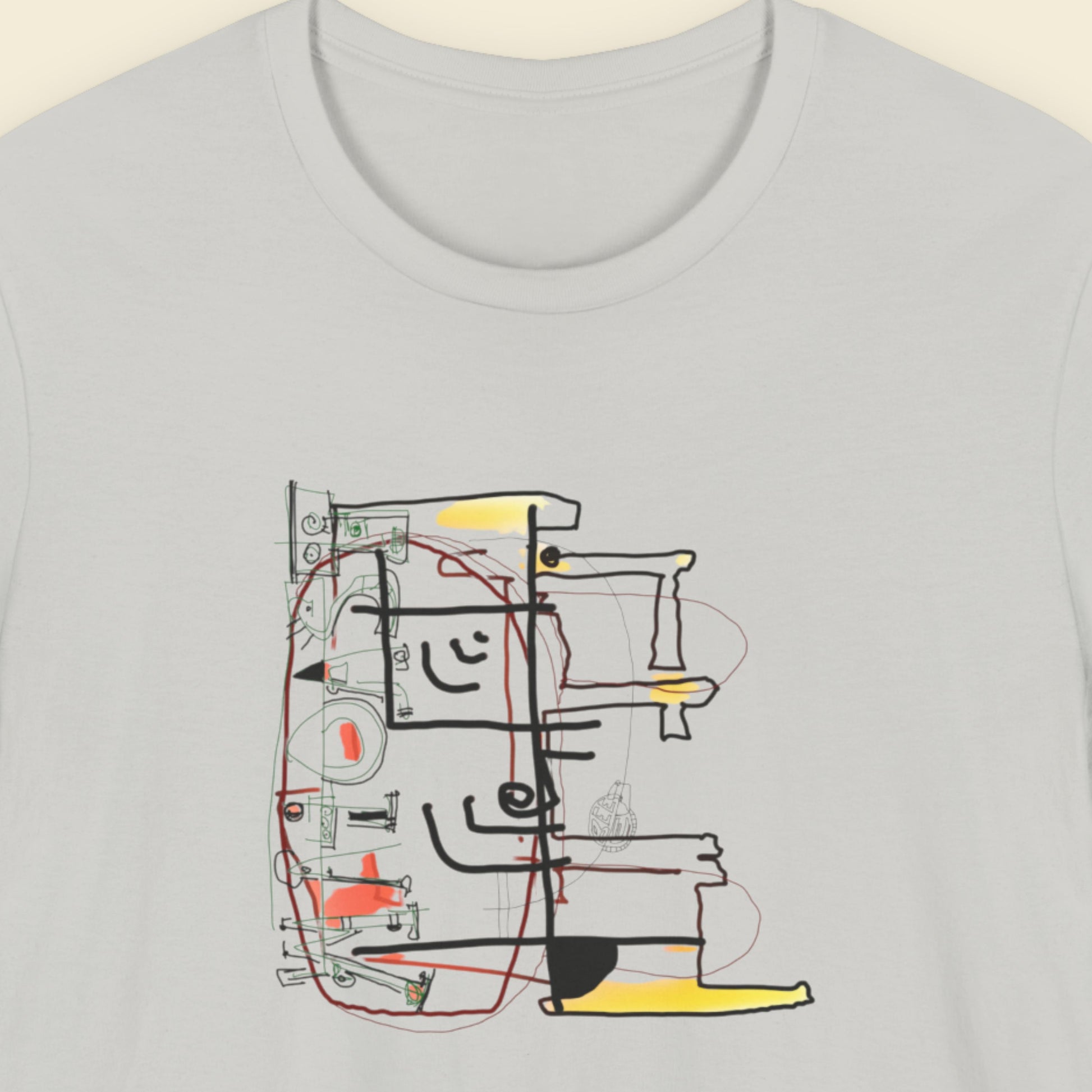 Grey t-shirt with a colorful abstract diagram drawing on a beige background.