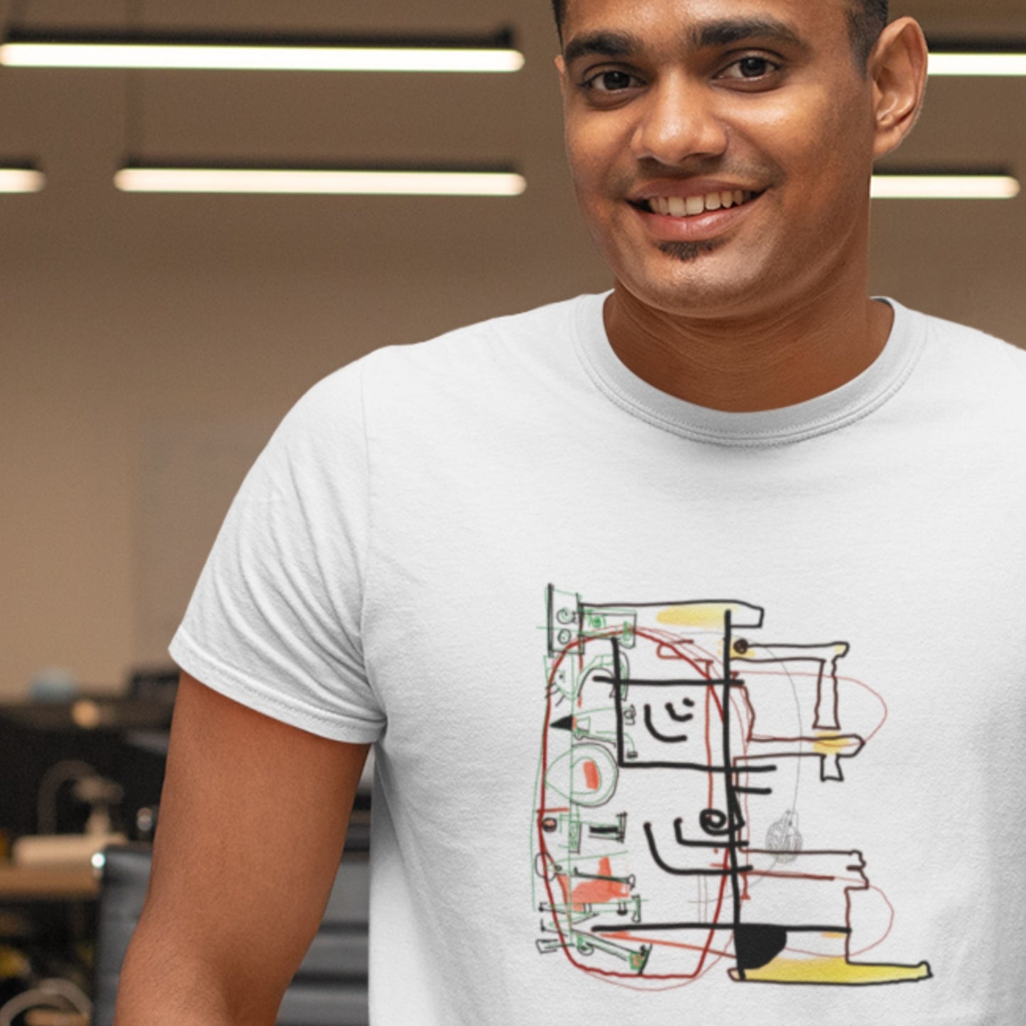 Smiling man wearing a white t-shirt with a colorful abstract diagram drawing in a lab.