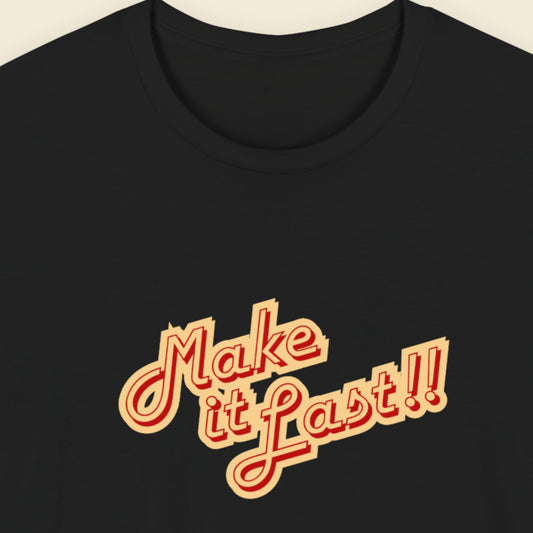 Black t-shirt with 'make it last!!' text in yellow and red on a beige background.