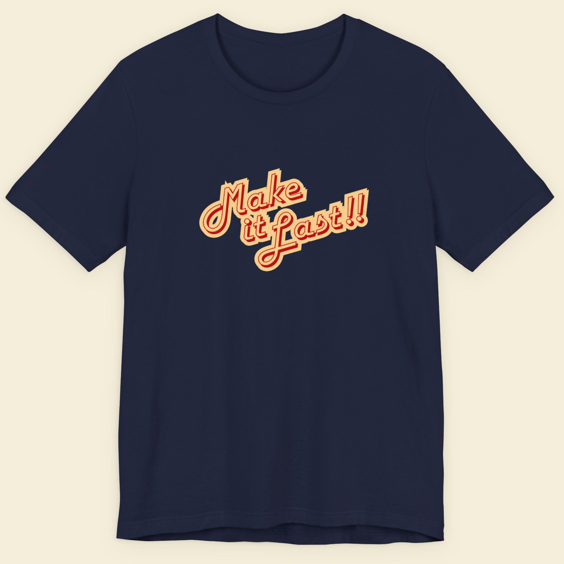 Navy t-shirt with 'make it last!!' text in yellow and red on a beige background.