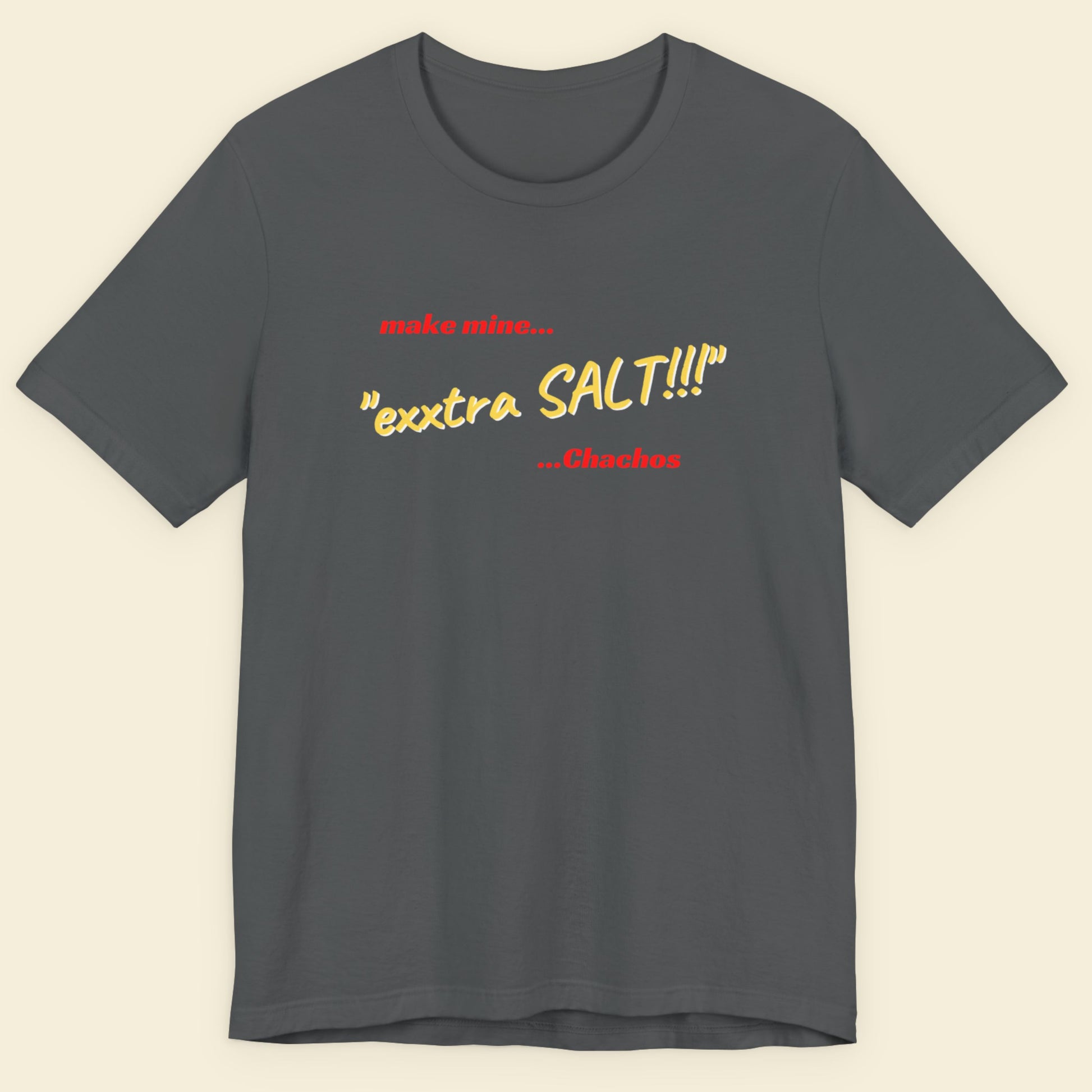 Gray t-shirt with colorful text on a beige background.