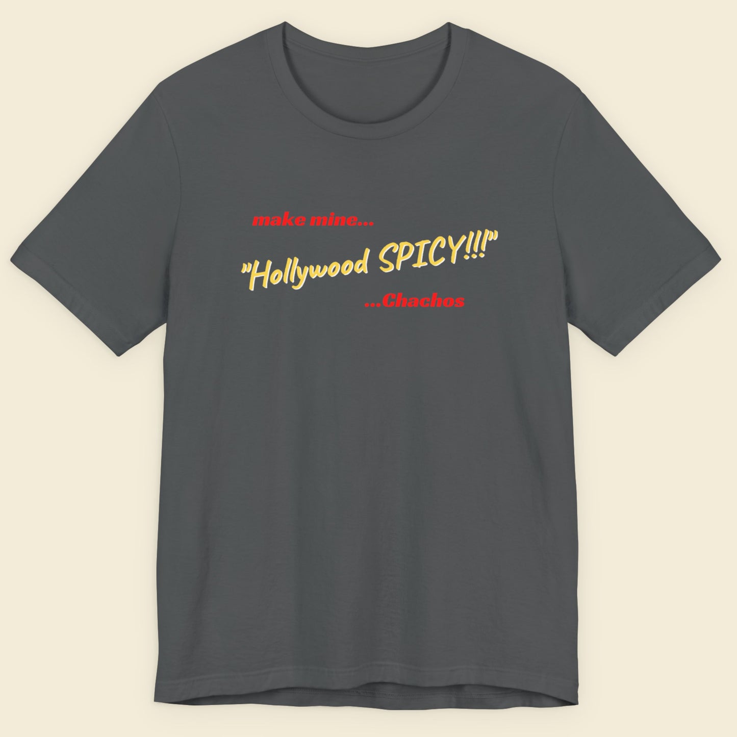 Grey t-shirt with humorous colorful text on a beige background.