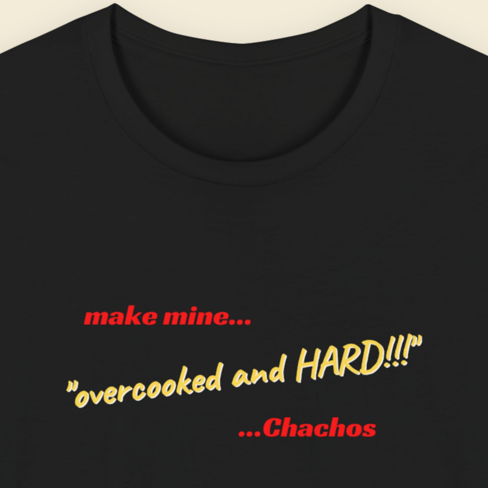 Black t-shirt with humorous colorful text on a beige background.