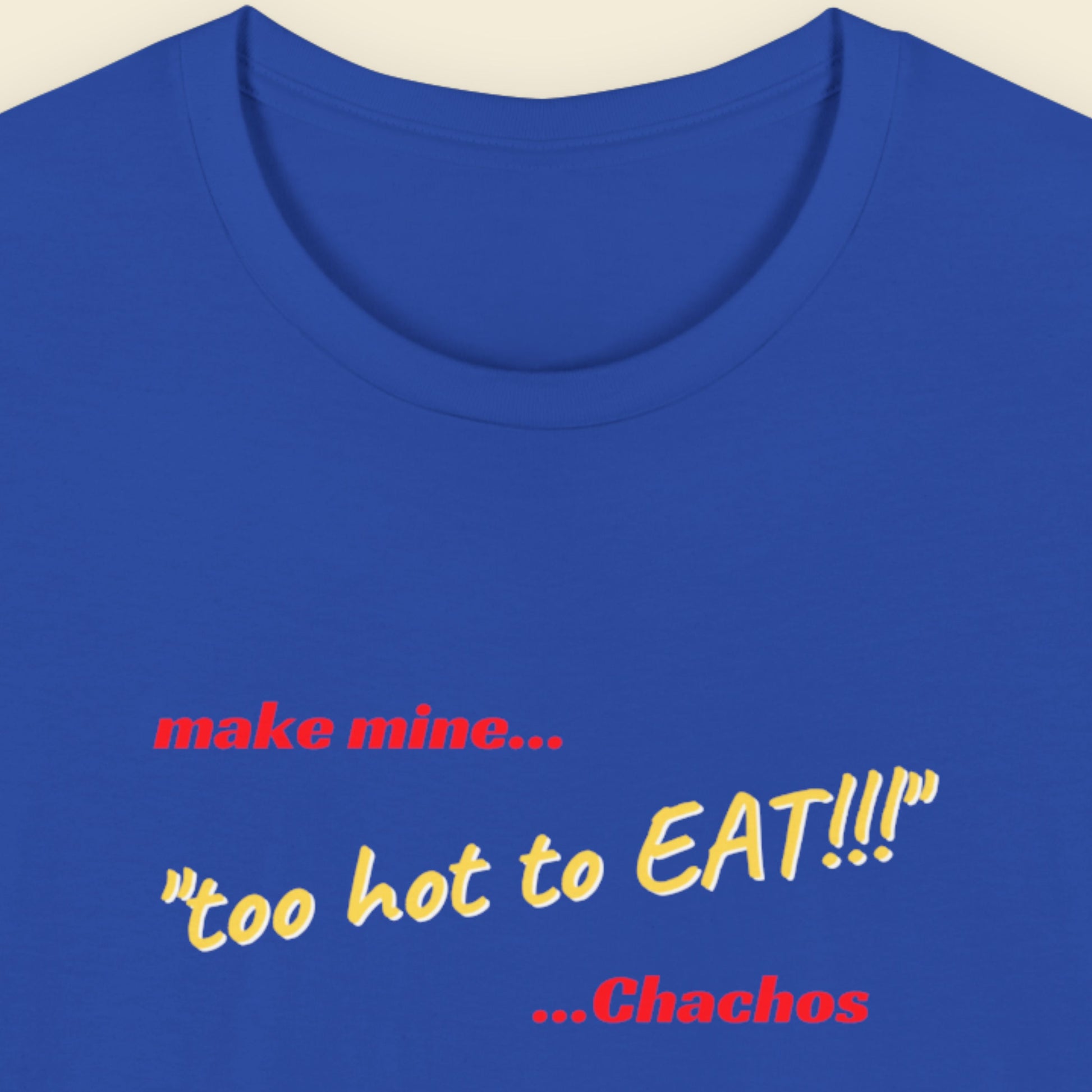 Blue t-shirt with humorous colorful text on a beige background.