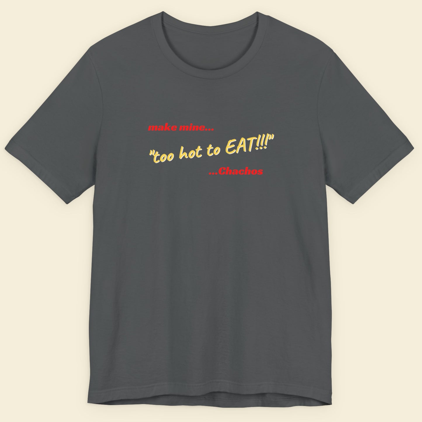 Grey t-shirt with humorous colorful text on a beige background.