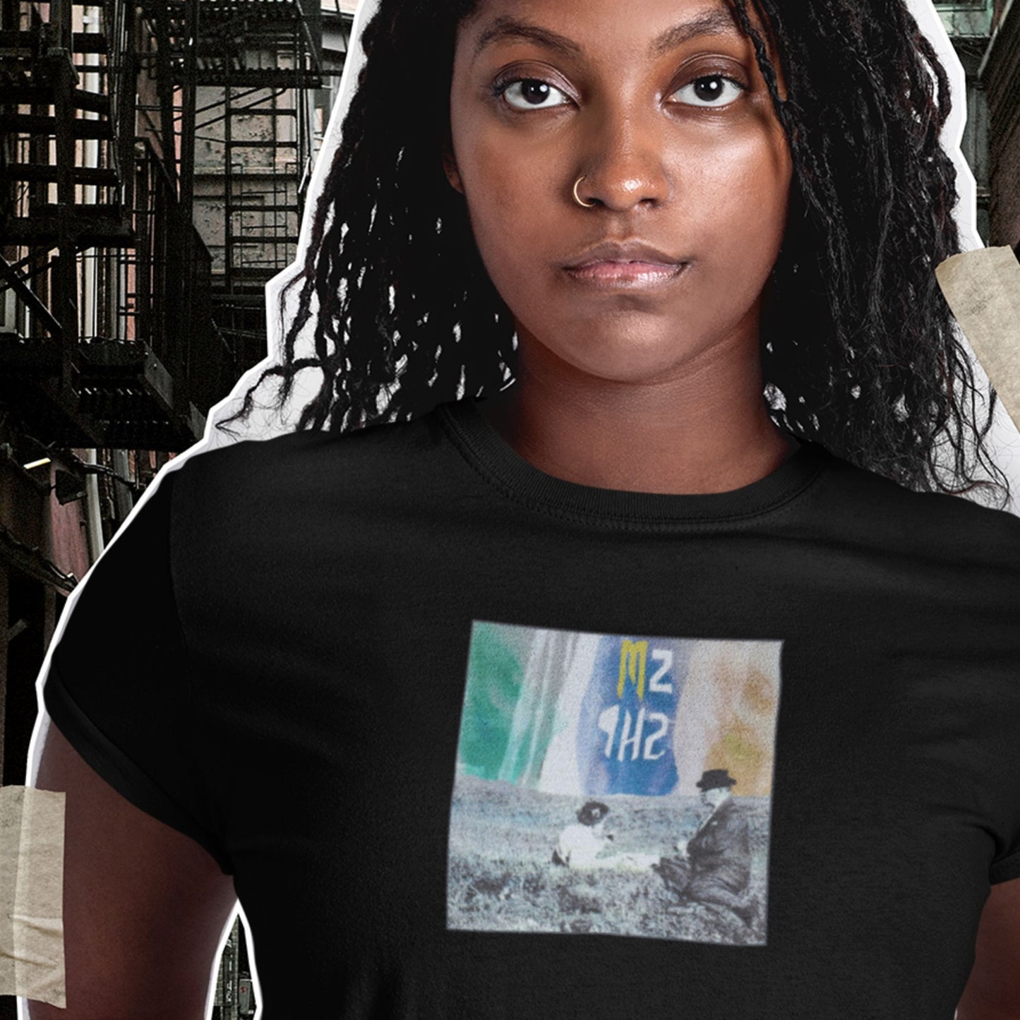 Person wearing a black t-shirt with a graphic design in an urban setting