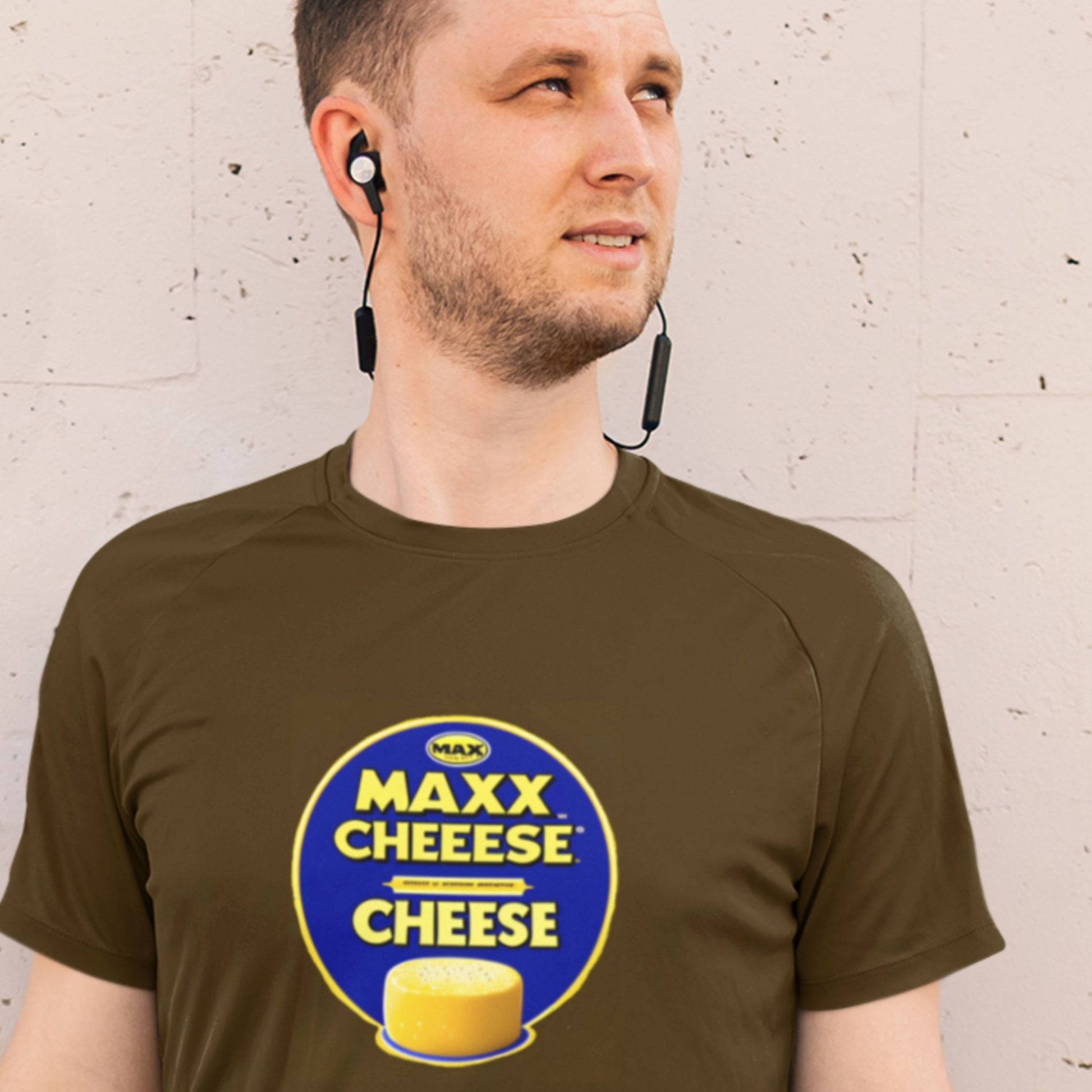 Man wearing a brown t-shirt with a fun, colorful cartoon illustration on a grey background.