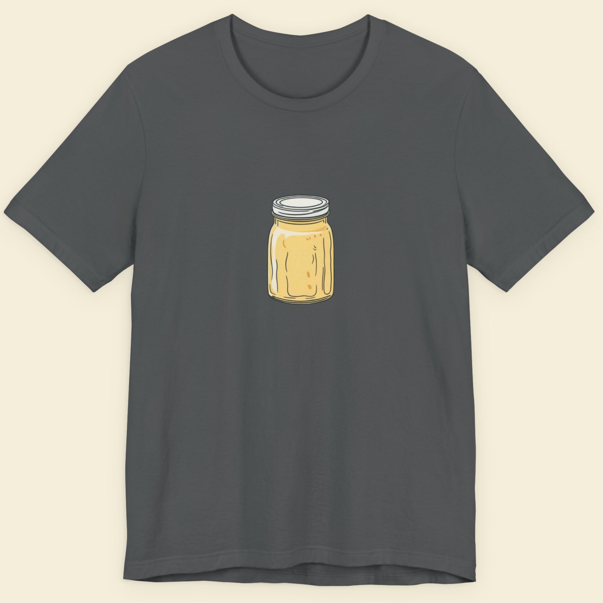 Grey t-shirt with a drawing of a melting yellow jar on a beige background.