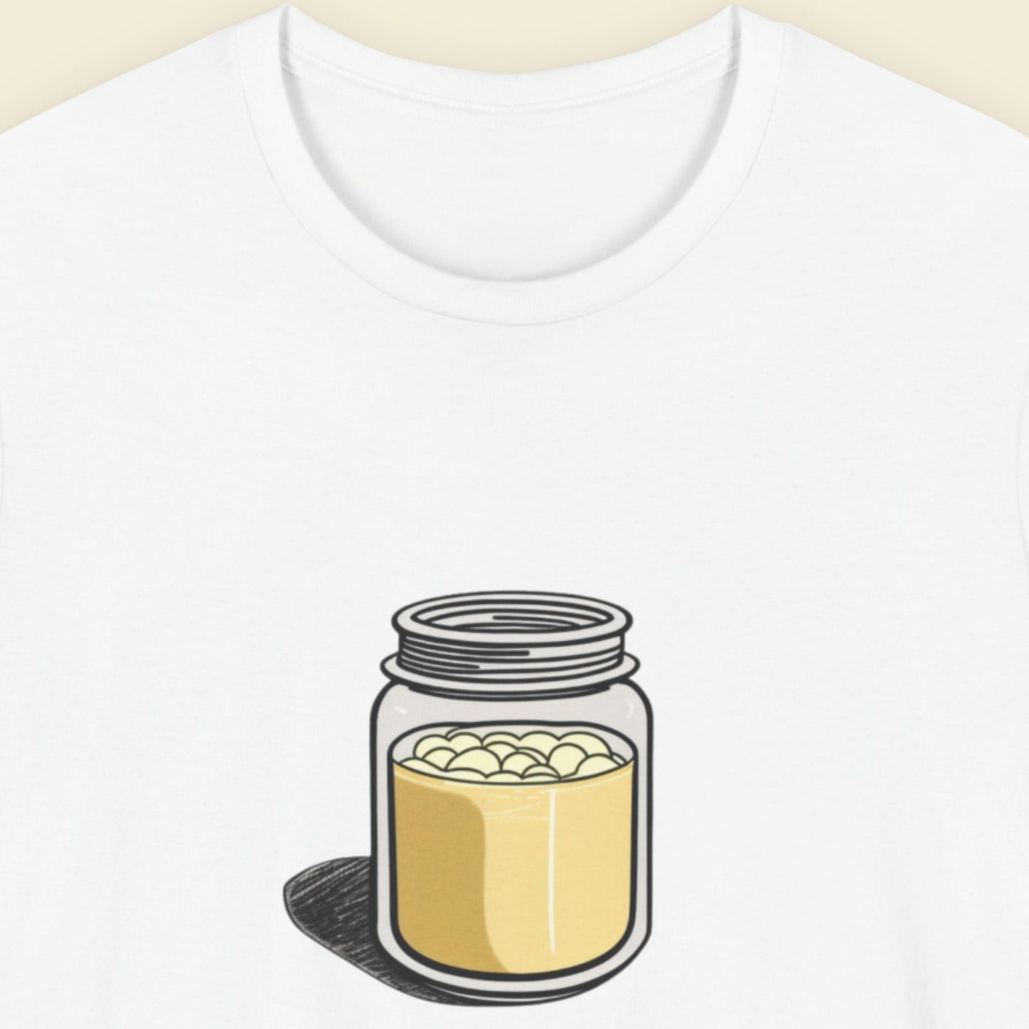 White t-shirt with a fun, colorful cartoon illustration on a beige background.