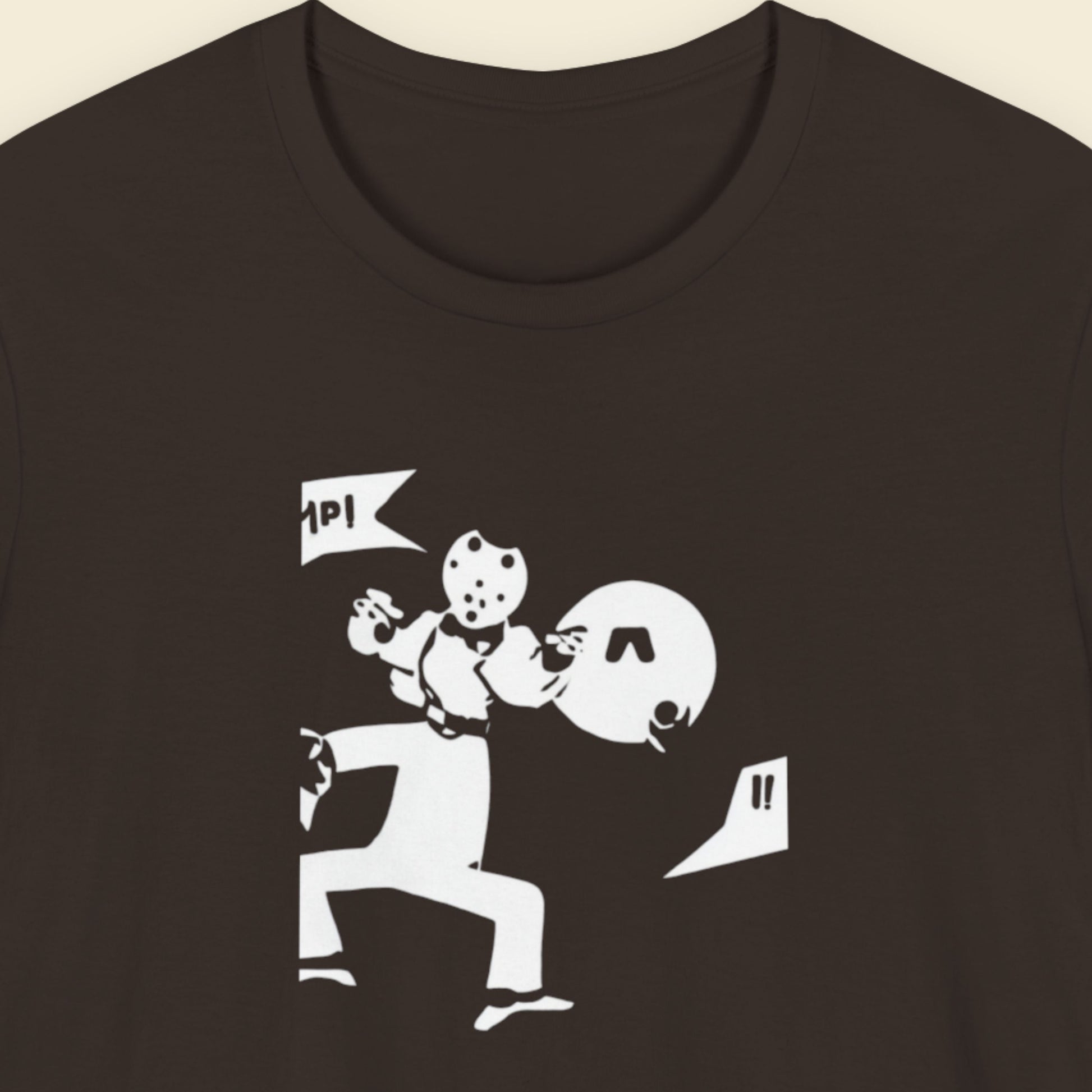 Brown t-shirt with a fun, cartoon illustration on a beige background.