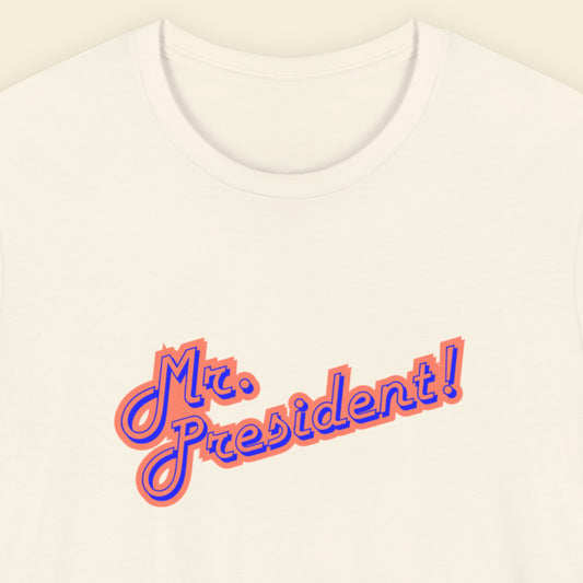 White t-shirt with 'Mr. President!' text in orange and blue on a beige background