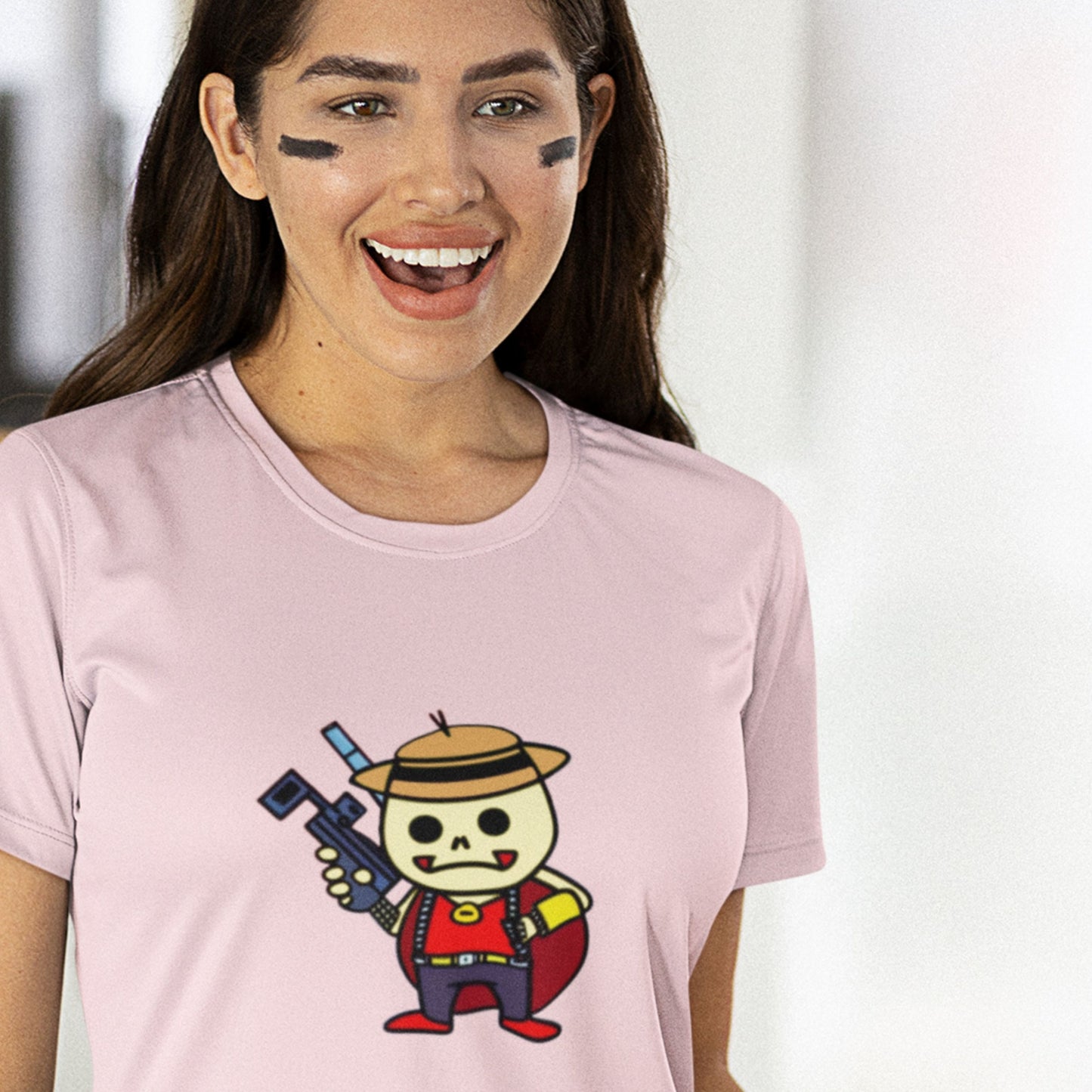 Sports woman wearing a pink t-shirt with a fun, colorful cartoon bounty hunter illustration in a living room.