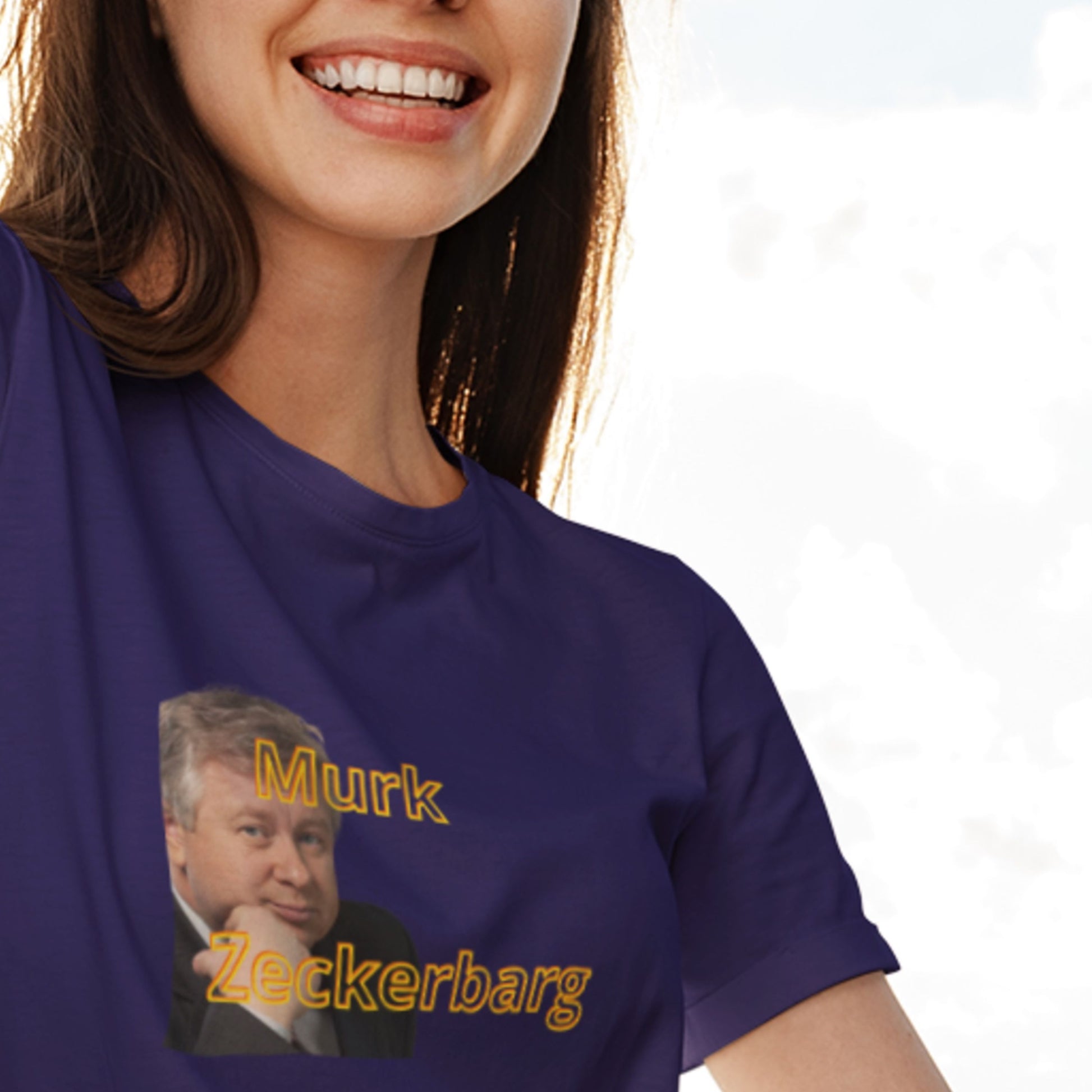 Person wearing a purple t-shirt with a graphic and text, on a plain background.