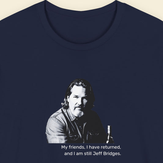 Navy blue t-shirt with humorous colorful text on a beige background.